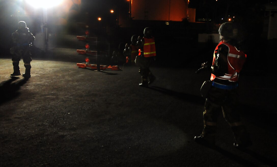 Three members along from the 154th headquarters office, searche for UXO’s as part of a par sweep drill during an Operational Readiness Inspection at Joint Base Pearl Harbor-Hickam, Hawaii, Nov. 7, 2013. This inspection demonstrates the effective use of Total Force Integration by including both 15th Wing and 154th Hawaii Air National Guard Airmen working side-by-side to accomplish the mission. (U.S. Air Force photo/Tech. Sgt. Michelle Thomas) 