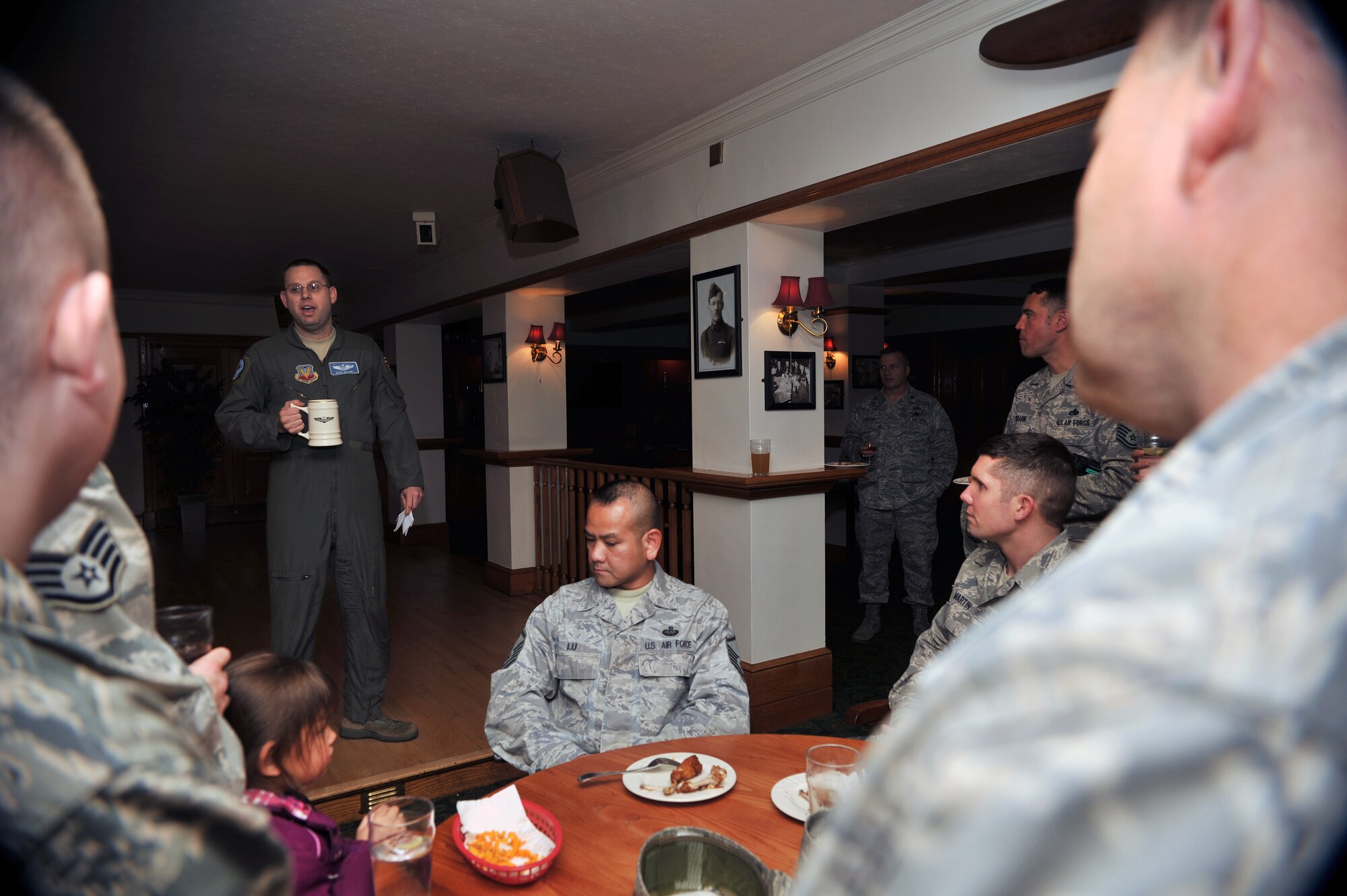 U.S. Air Force Capt. Brad Maxon, 95th Reconnaissance Squadron executive officer, explains what the Doolittle Raiders accomplished Nov. 8, 2013, prior to a giving a toast in the Tudor Bar on RAF Mildenhall, England. In April 1942, 80 men known as the Doolittle Raiders took part in a daring mission. The 95th RS’s legacy unit, the 95th Bomb Squadron, made up six of the 16 crews that struck the Japanese homeland. (U.S. Air Force photo by Senior Airman Christine Griffiths/Released)