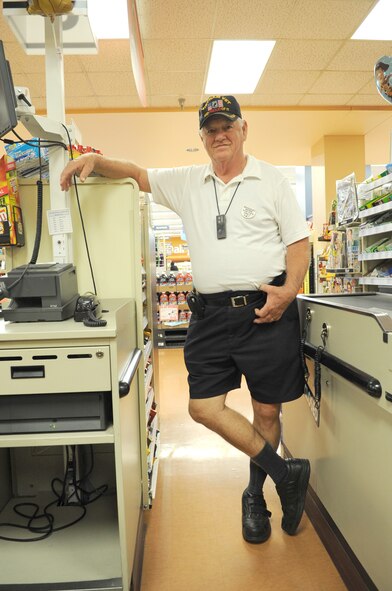 Retired Army Sgt. 1st Class Bill Medinger, a bagger at the Luke Air Force Base Commissary, stands in a checkout lane Oct. 28 where his customers see him on a daily basis. Medinger served in the Army for 20 years and in Vietnam from 1968 to 1970. During his tour, he flew as a light operator and a volunteer door gunner. (U.S. Air Force photo/Staff Sgt. Nestor Cruz)