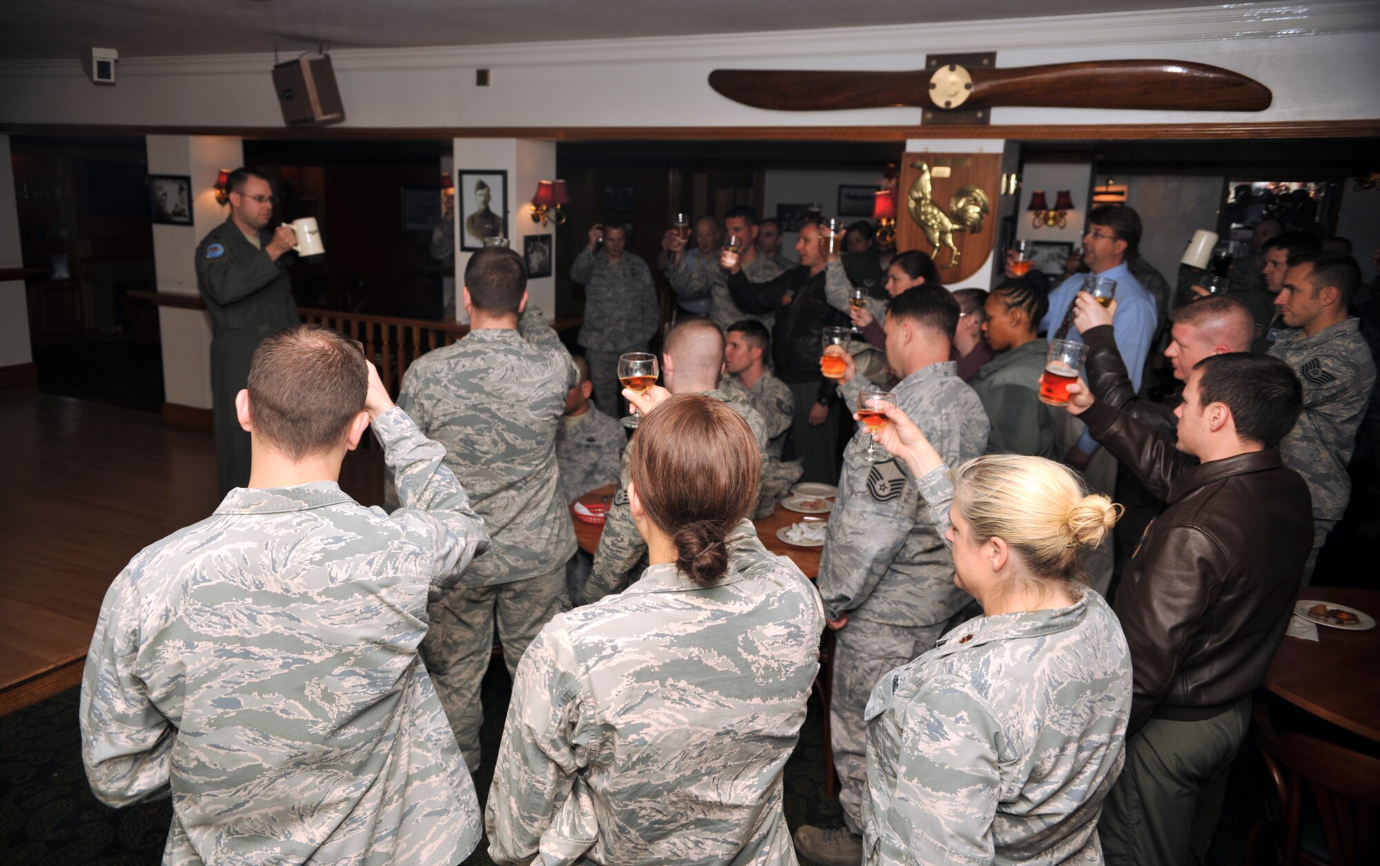 Team Mildenhall personnel raise their glasses to toast the four remaining Doolittle Raiders Nov. 8, 2013, in the Tudor Bar on RAF Mildenhall, England. In April 1942, 80 men known as the Doolittle Raiders took part in a daring mission to strike the Japanese homeland in retaliation of the Pearl Harbor attack Dec. 7, 1941. The mission was thought to be impossible, yet it was highly successful. (U.S. Air Force photo by Senior Airman Christine Griffiths/Released)