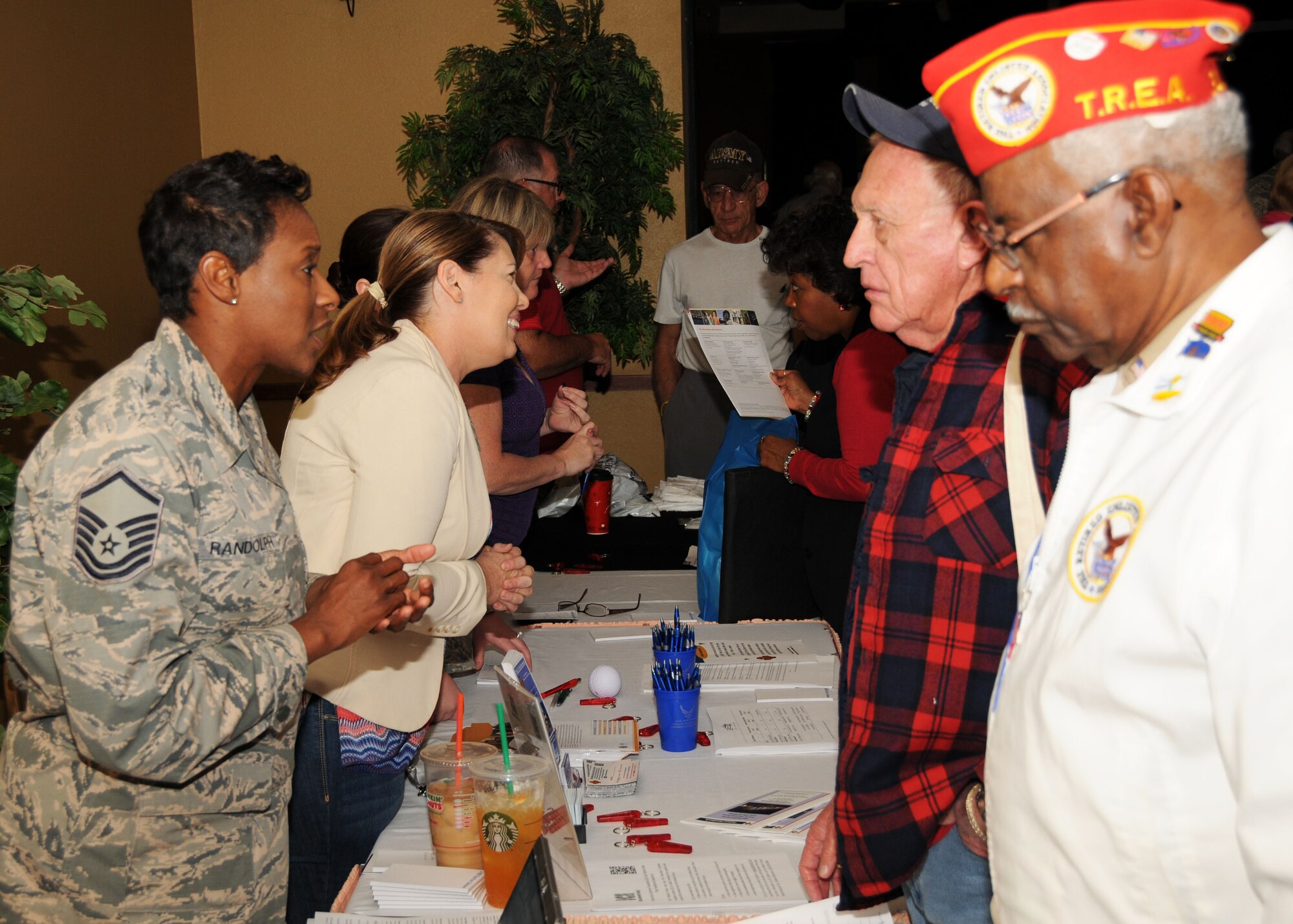 Master Sgt. Shawanda Randolph, 56th Medical Group Tricare superintendent, Cathleen Bilczewski, patient advocate and Debra Pare, customer service referral, talk with retirees Saturday. (U.S. Air Force photo/Tech. Sgt. Louis Vega Jr.)