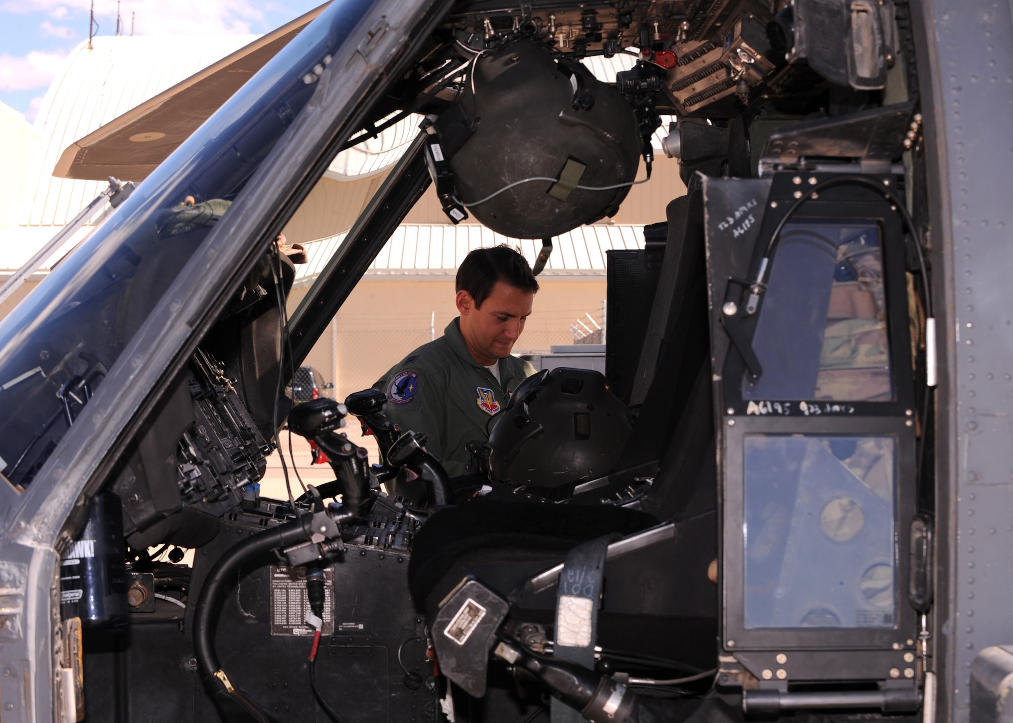 Capt. Brian R. Dicks, 55th Rescue Squadron pilot, prepares for a flight on an HH-60G Pave Hawk helicopter at Davis-Monthan AFB, Ariz., Nov. 4, 2013.  Dicks was honored with the Air Rescue Association?s 2013 Richard T. Knight Award for demonstrating his rescue expertise while flying seven high-risk casualty evacuation missions during a deployment to Afghanistan. (U.S. Air Force Photo by Airman 1st Class Chris Massey/Released)(cropped)