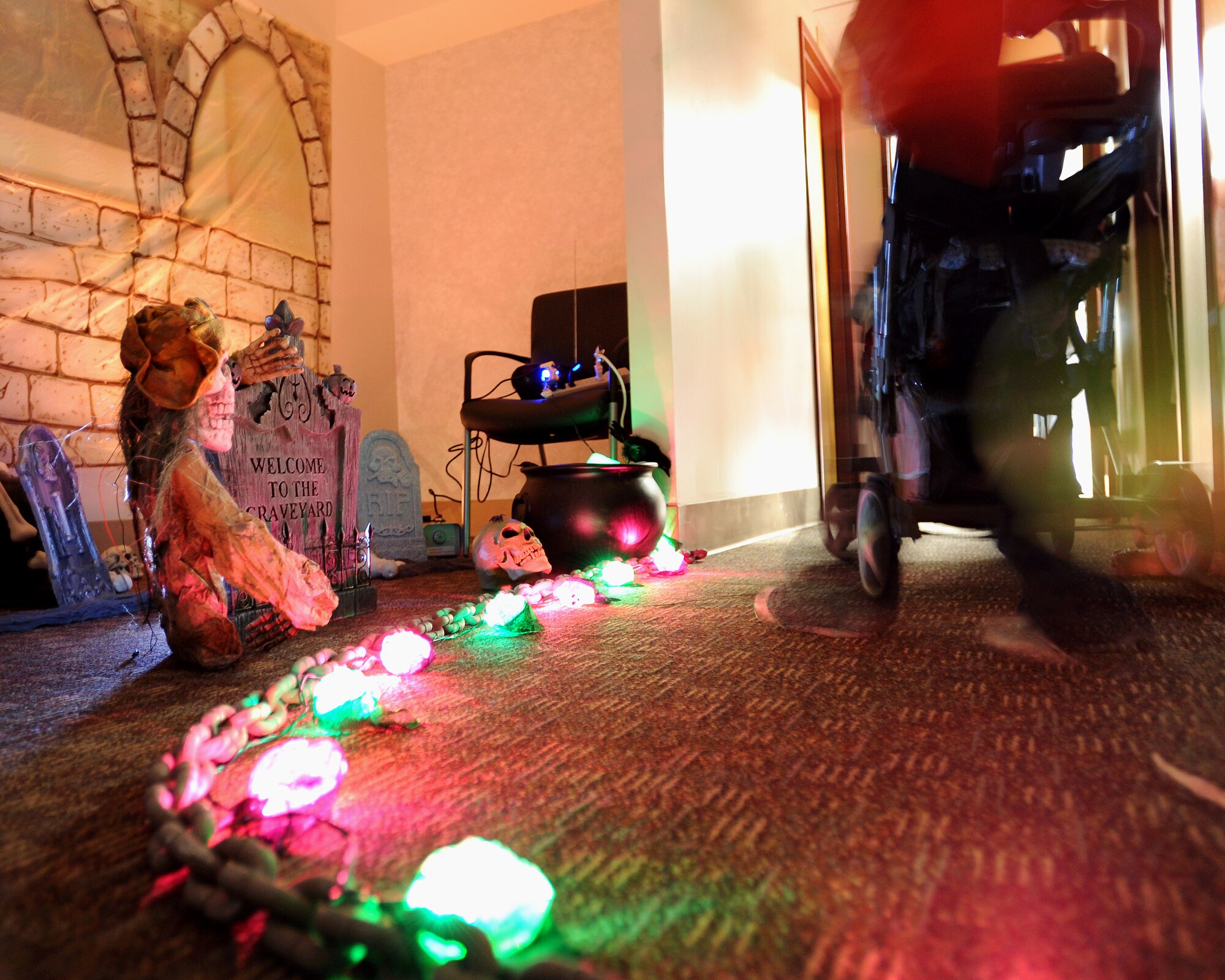 Trick-or-treaters and their families walk through a haunted hallway in the 319th Medical Group during the annual indoor trick-or-treating event Oct. 31, 2013, on Grand Forks Air Force Base, N.D. The 319th Medical Group hosts trick-or-treating every year as a way for children and families to enjoy the holiday. (U.S. Air Force Photo/Airman 1st Class Zachiah Roberson)