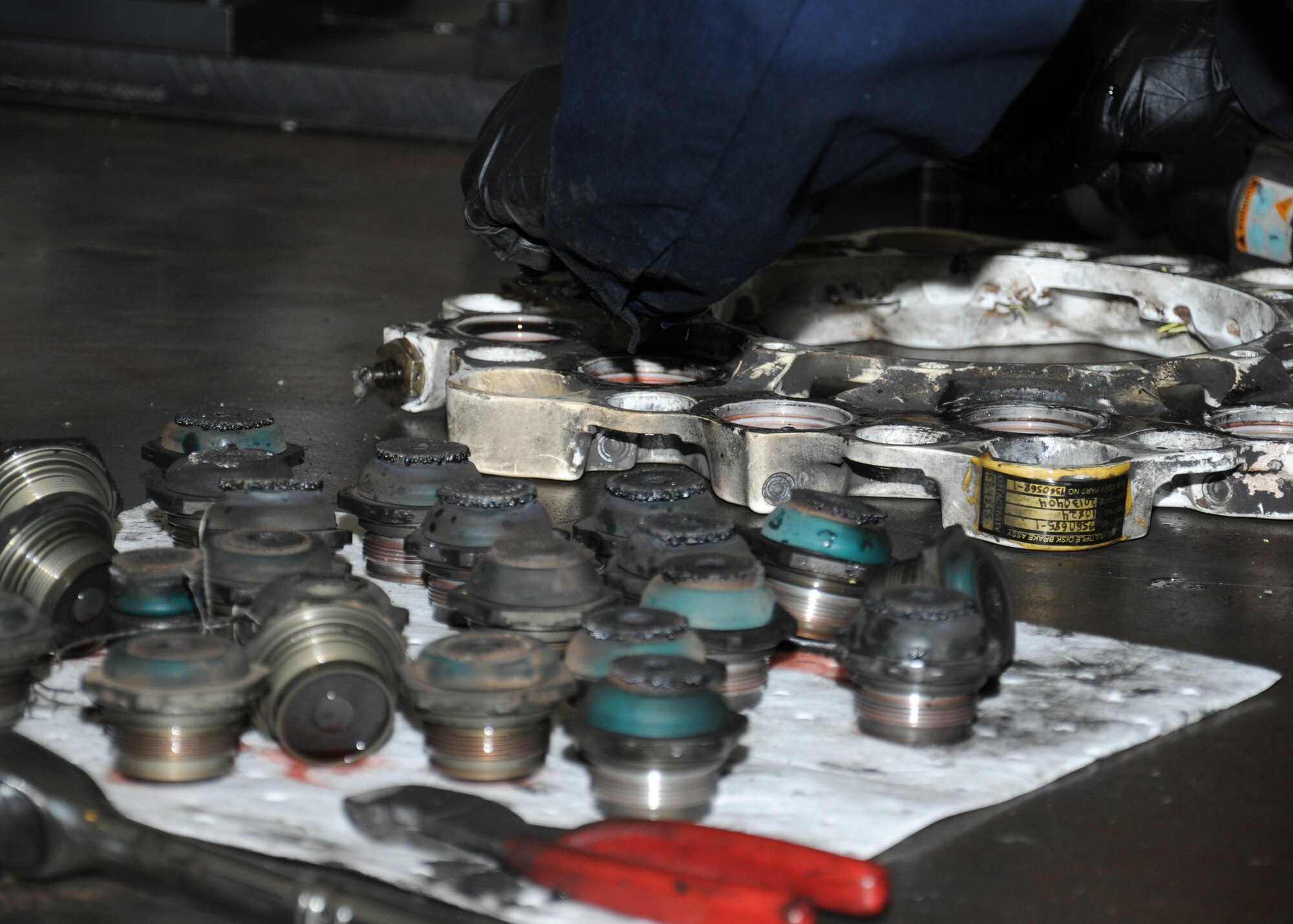 U.S. Air Force Tech. Sgt. Eric Vangsness, 100th Maintenance Squadron hydraulics backshop assistant section chief from Decorah, Iowa, disassembles a C-130 brake in order to overhaul it and ensure it is serviceable to be reused on an aircraft Nov. 1, 2013, on RAF Mildenhall, England. The 100th MXS hydraulics backshop personnel’s main role is to overhaul parts for all the aircraft on RAF Mildenhall. The personnel are the only overseas shop that overhauls aerial refueling boom assemblies, making them crucial in the tanker mission. (U.S. Air Force photo by Gina Randall/Released)