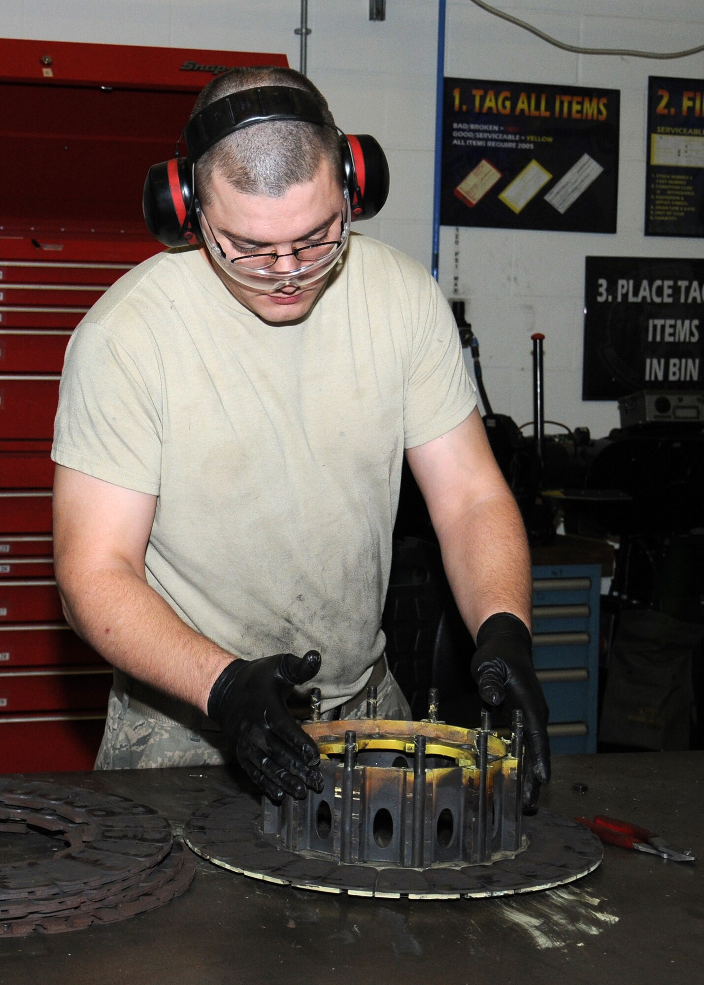 U.S. Air Force Senior Airman Casey Jackson, 100th Maintenance Squadron aircraft hydraulics systems journeyman from Columbus, Ohio, disassembles a C-130 brake in order to overhaul it and ensure it’s serviceable to be reused on an aircraft Nov. 1, 2013, on RAF Mildenhall, England. The 100th MXS hydraulics backshop personnel’s main role is to overhaul parts for all the aircraft on RAF Mildenhall. The personnel perform isochronal-phase inspections for the KC-135 Stratotankers, an extremely in-depth inspection of the aircraft involving changing every hydraulic filter on the aircraft, un-installing the boom for inspection and then reinstalling it. (U.S. Air Force photo by Gina Randall/Released)