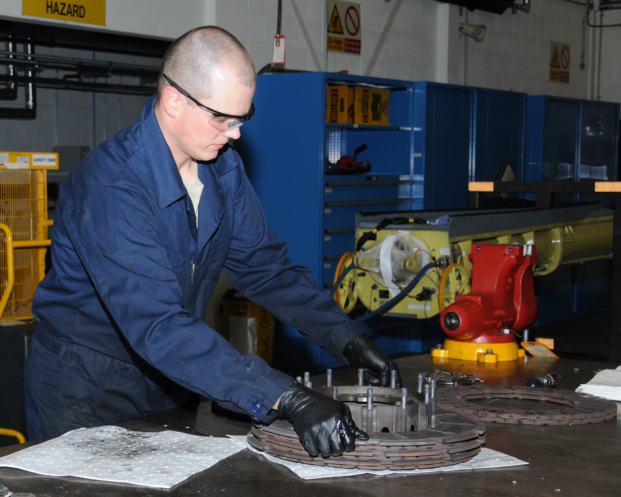 U.S. Air Force Tech. Sgt. Eric Vangsness, 100th Maintenance Squadron hydraulics backshop assistant section chief from Decorah, Iowa, disassembles a C-130 brake in order to overhaul it and ensure it’s serviceable to be reused on an aircraft Nov. 1, 2013, on RAF Mildenhall, England. The 100th MXS hydraulics backshop personnel’s main role is to overhaul parts for all the aircraft on RAF Mildenhall. The personnel work on KC-135 Stratotanker, C-130J Super Hercules four-engine turboprop, MC-130J Commando II and CV-22B Osprey aircraft. (U.S. Air Force photo by Gina Randall/Released) 