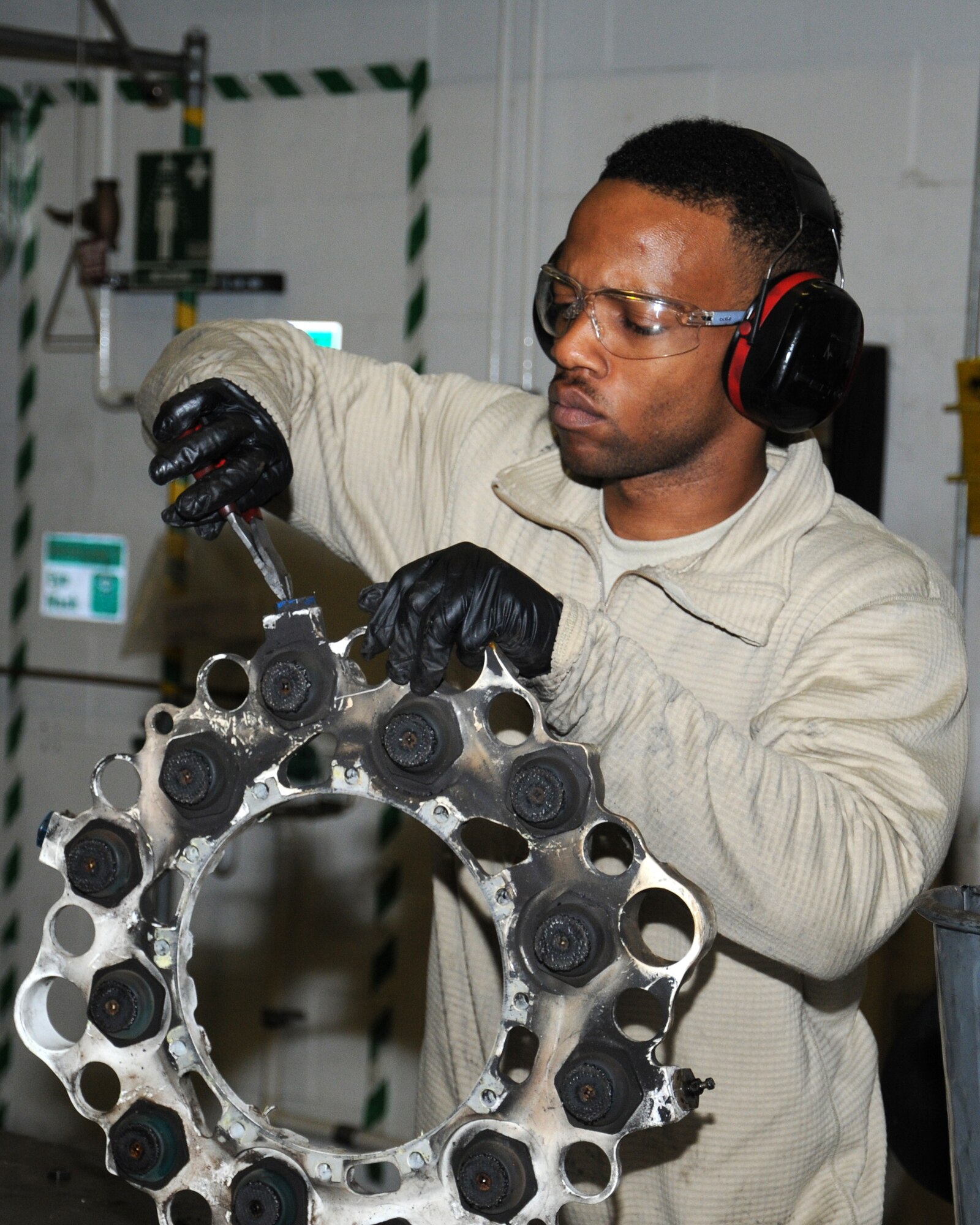 U.S. Air Force Senior Airman Christopher Francis, 100th Maintenance Squadron aircraft hydraulics systems journeyman from Rockville, Md., disassembles a C-130 brake in order to overhaul it and ensure it’s serviceable to be reused on an aircraft Nov. 1, 2013, on RAF Mildenhall, England. The 100th MXS hydraulics backshop personnel’s main role is to overhaul parts for all the aircraft on RAF Mildenhall. The shop is the only overseas repair center that overhauls aerial refueling boom assemblies, making them crucial in the tanker mission. (U.S. Air Force photo by Gina Randall/Released) 