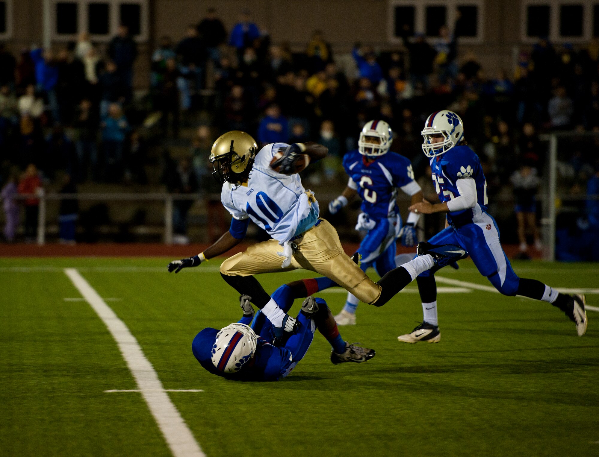 Wiesbaden Warriors’ running back, C.J. Pridgen, tramples over Ramstein Royals’ corner back, Johnny Pack, during the Department of Defense Dependents Schools Europe Division 1 football championship game Nov. 2, 2013, Kaiserslautern, Germany. The Warriors defeated the Royals 38-21. (U.S. Air Force photo/Senior Airman Damon Kasberg)