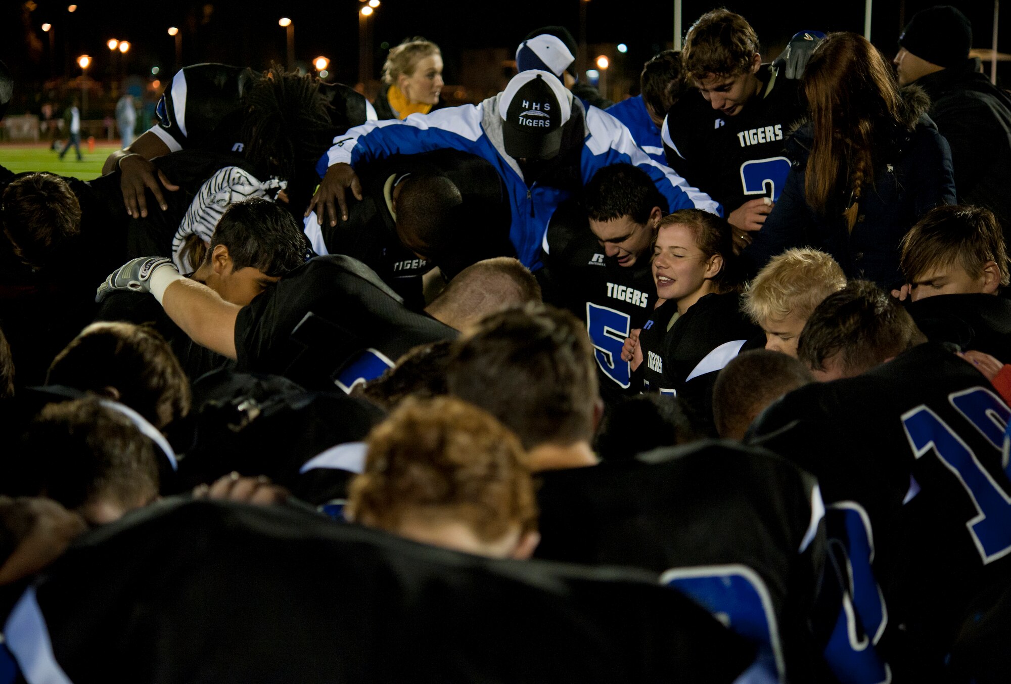 The Hohenfels Tigers pray together after winning the Department of Defense Dependents Schools Europe Division 2 football championship game Nov. 2, 2013, Kaiserslautern, Germany. Behind 35-18, the Tigers scored three touchdowns in the fourth quarter to claim victory over the SHAPE Spartans. (U.S. Air Force photo/Senior Airman Damon Kasberg)