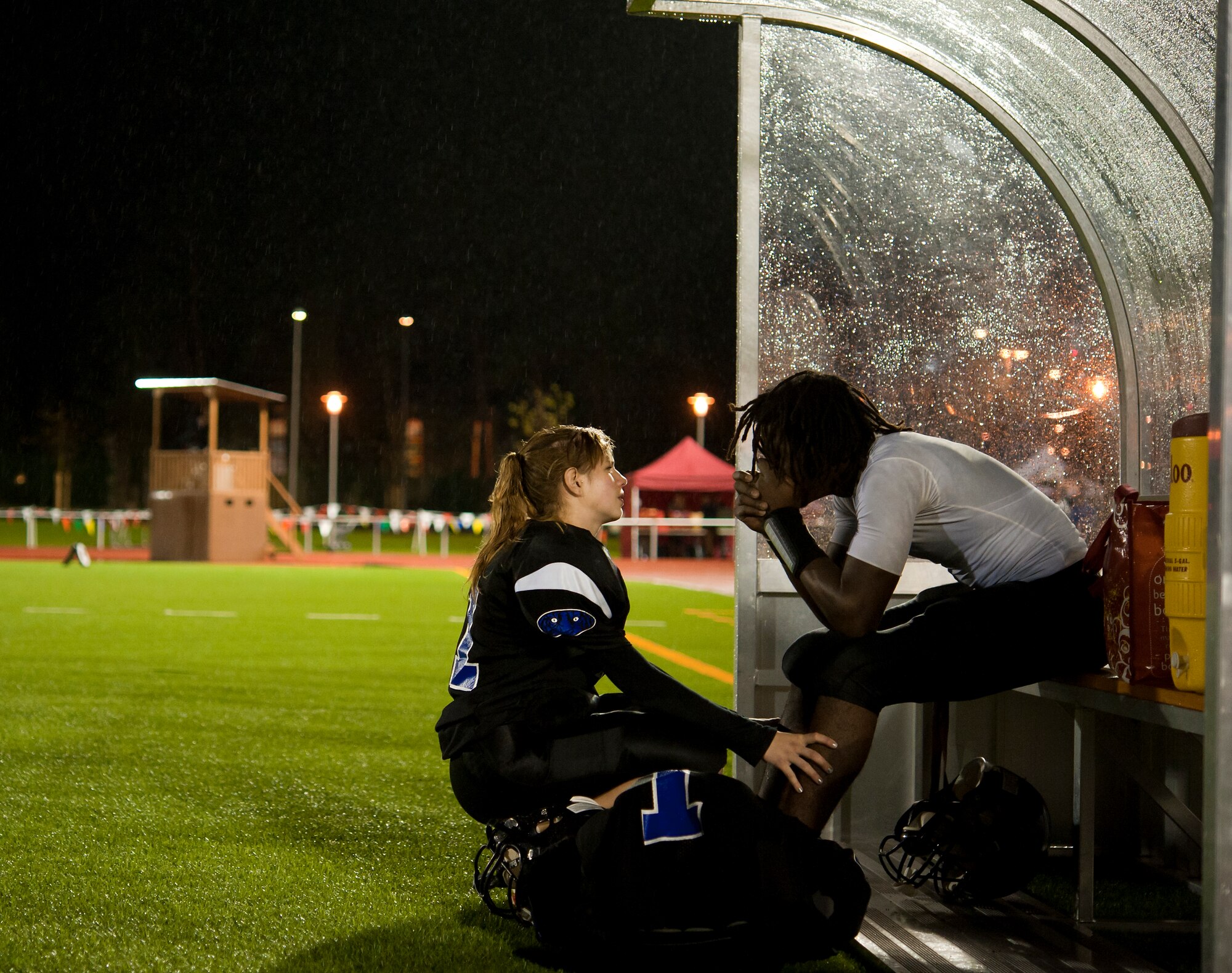 Hohenfels Tiger wide receiver, Shelby Atkinson (left), comforts her teammate wide receiver, Tony Saintmelus, after he suffered an injury in the third quarter of the Department of Defense Dependents Schools Europe Division 2 football championship game Nov. 2, 2013, Kaiserslautern, Germany. The Tigers were down 35-18 with less than 10 minutes remaining in the fourth quarter, but rallied, scoring 20 points to claim victory. Saintmelus returned late in the fourth quarter to intercept a deep pass from SHAPE’s quarterback ending the game. (U.S. Air Force photo/Senior Airman Damon Kasberg)