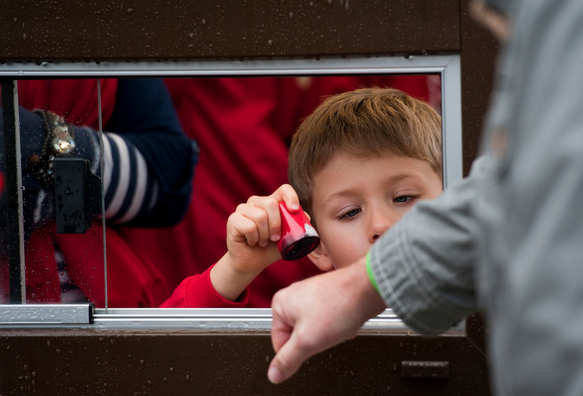 Julian Grogan, son of Chris Grogan, Kaiserslautern High School teacher, stamps the hand of a ticket holder before they enter the Kaiserslautern stadium to watch the Department of Defense Dependents Schools Europe football championship games, Nov. 2, 2013, Kaiserslautern, Germany. The Division 2 game featured the SHAPE Spartans and the Hohenfels Tigers, and the Division 1 game featured the Ramstein Royals and the Wiesbaden Warriors. (U.S. Air Force photo/Senior Airman Damon Kasberg)