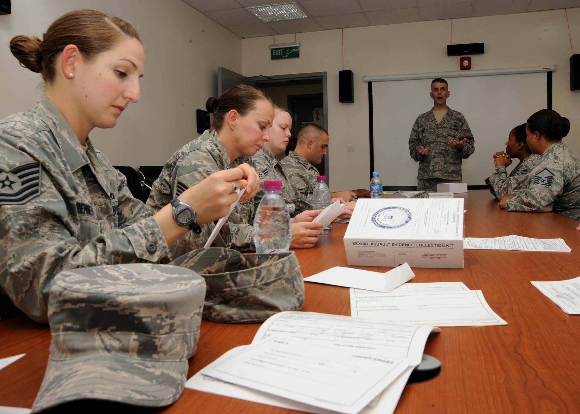 Maj. Scott Crum goes over the contents of a Sexual Assault Evidence Collection Kit during a victim advocacy training course at the 379th Air Expeditionary Wing in Southwest Asia, Nov. 2, 2013. Looking at the kits allowed the volunteers to gain insight on what victims may have to encounter when they visit the hospital for a sexual assault forensic evidence exam. Crum is the 379th AEW sexual assault response coordinator deployed from Joint Base San Antonio-Randolph, Texas, and a Clifton, N.J., native. (U.S. Air Force photo/ Senior Airman Bahja J. Jones) 
