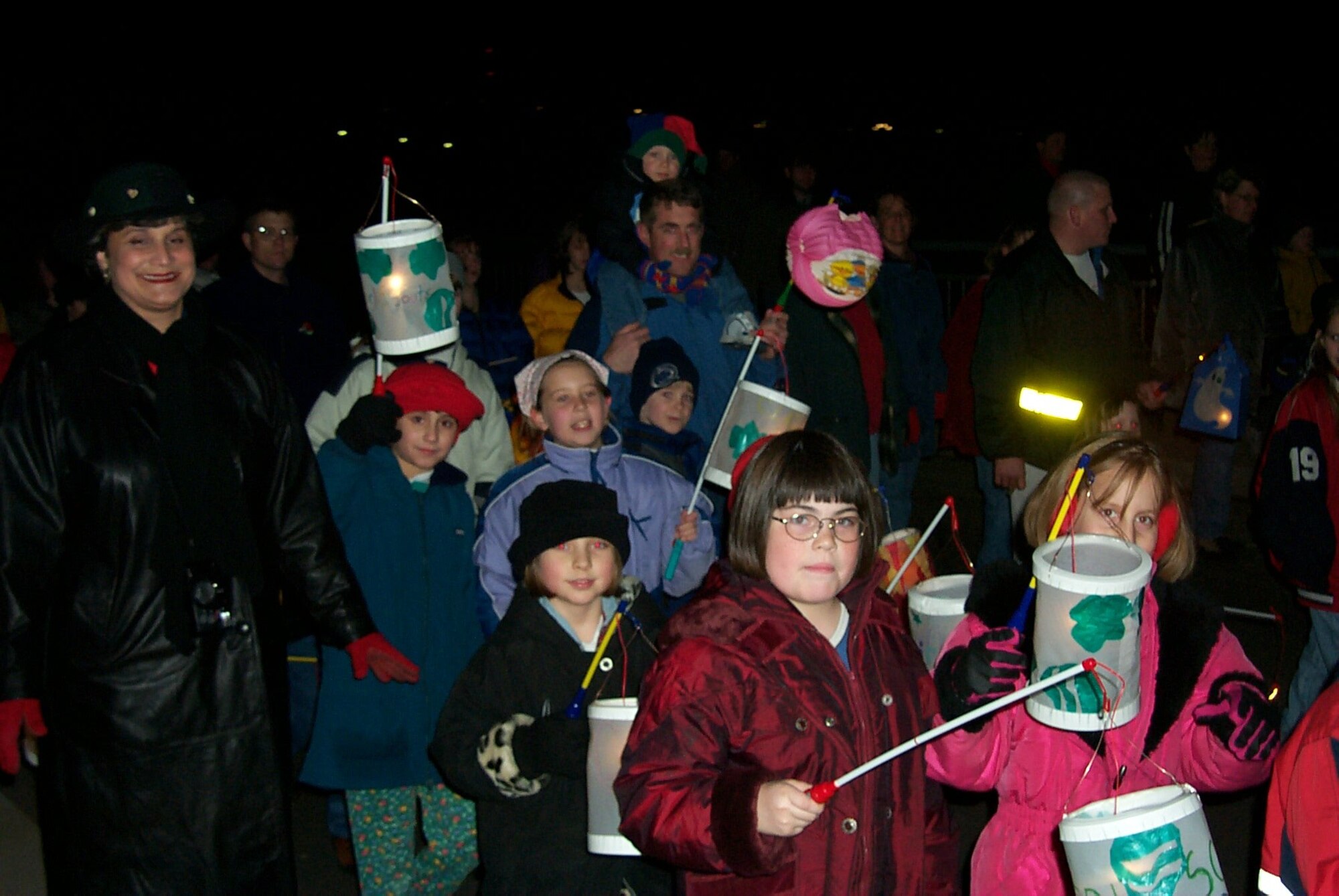 SPANGDAHLEM AIR BASE, Germany-- Local children carry colorful lanterns as they march through the streets of Spangdahlem village in a past Saint Martin procession. This year, parades are scheduled to take place tonight through next week with the dates and times varying from town to town. In some towns, firefighters lead the parade with torches in hand, followed by the town band and a man portraying St. Martin, clad in the uniform of a Roman legionnaire, on horseback. The colorfully illuminated processions end with a huge bonfire. "St. Martin" then encourages the children and hands out large sugar pretzels. The Saint Martin parade is a perfect event for small children with their parents. Local villages invite the American neighbors to participate in this traditional local event. (U.S. Air Force photo by Iris Reiff) 