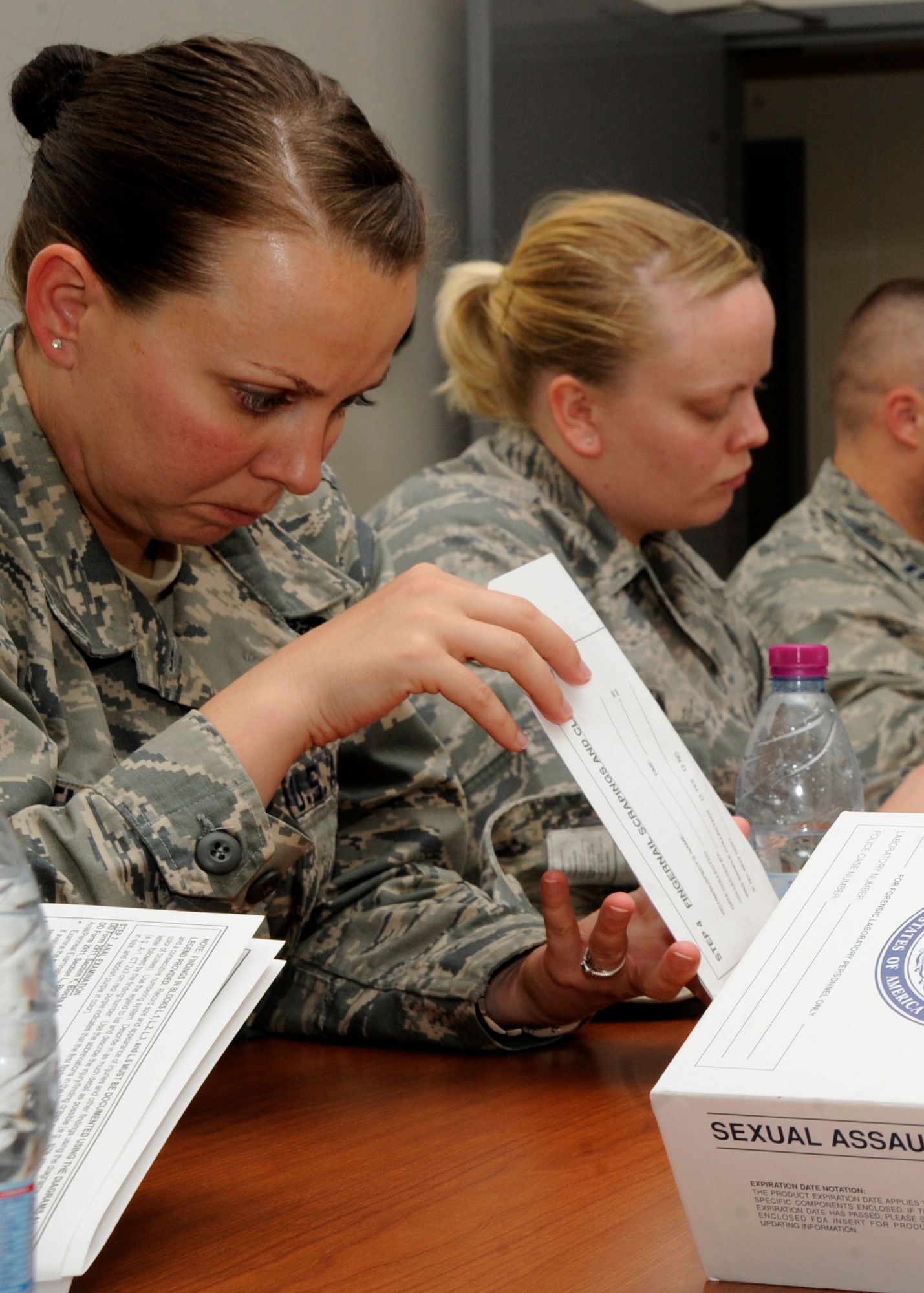 Tech. Sgt. Casandra Nevins looks through a Sexual Assault Evidence Collection Kit during a victim advocacy training course at the 379th Air Expeditionary Wing in Southwest Asia, Nov. 2, 2013. Looking at the kits allowed the volunteers to gain insight on what victims may have to encounter when they visit the hospital for a sexual assault forensic evidence exam. Nevins is the 379th Expeditionary Civil Engineer Squadron emergency management plans and operations NCO in charge deployed from Peterson Air Force Base, Colo., and Dayton, Ohio, native. (U.S. Air Force photo/Senior Airman Bahja J. Jones) 