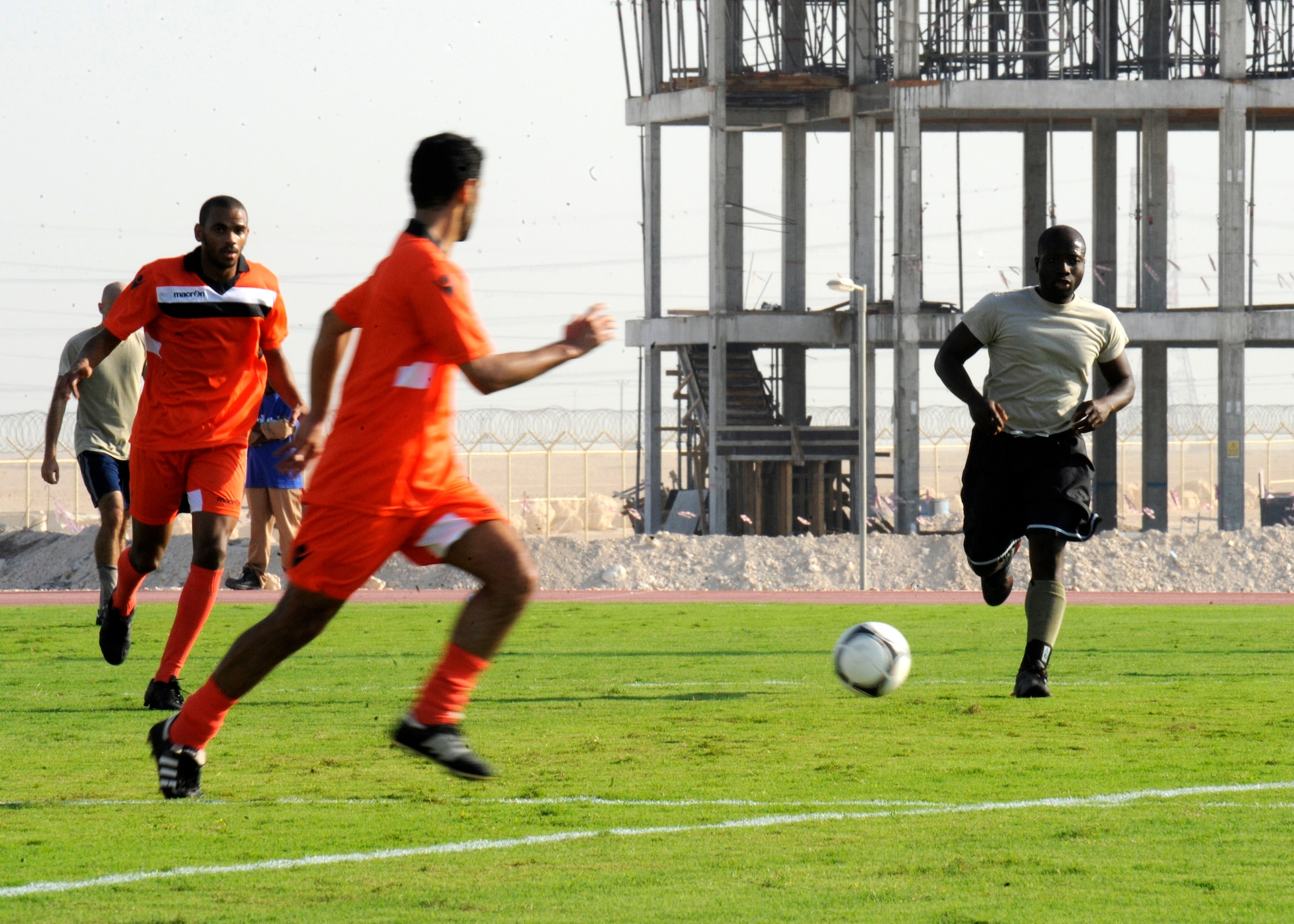 U.S. Air Force service members faceoff against host nation service members during a friendly soccer game at the 379th Air Expeditionary Wing in Southwest Asia, Oct. 31, 2013. The games were held at the local military compound’s soccer stadium, and hosted by the local base commander Brig. Gen. Abdulla Jassim Al Meraikhi.  (U.S. Air Force photo/Senior Airman Bahja J. Jones)  