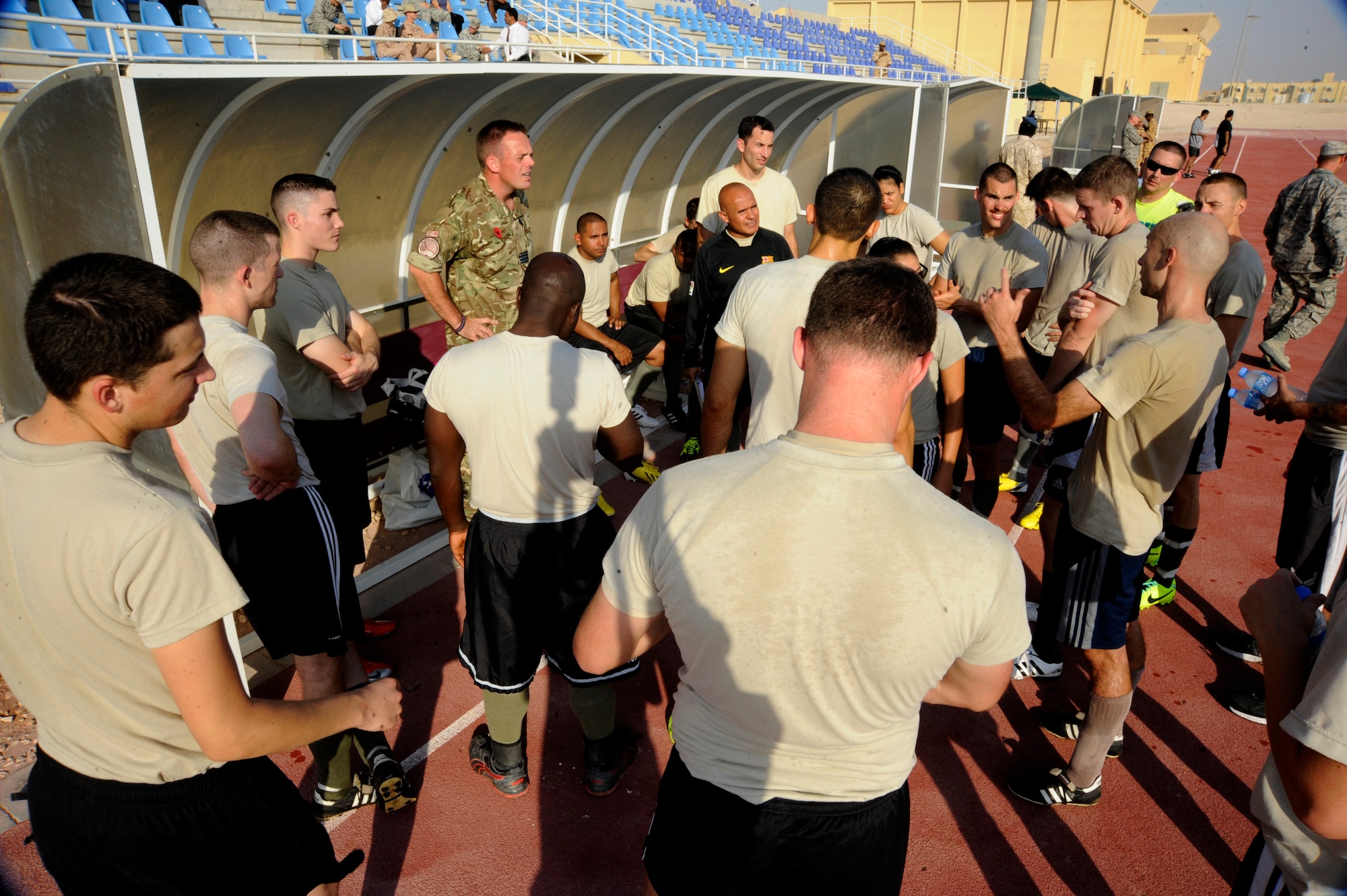 Royal Air Force Squadron Leader Lee Wood gives the U.S. Air Force players a pep-talk during a friendly soccer game between the U.S. Air Force and the host nation service members Oct. 31, 2013. The game was the third and final in a series of games between U.S., RAF, and host nation service members. Wood is the U.S. Air Forces Central Command air and space management officer. (U.S. Air Force photo/Senior Airman Bahja J. Jones)  