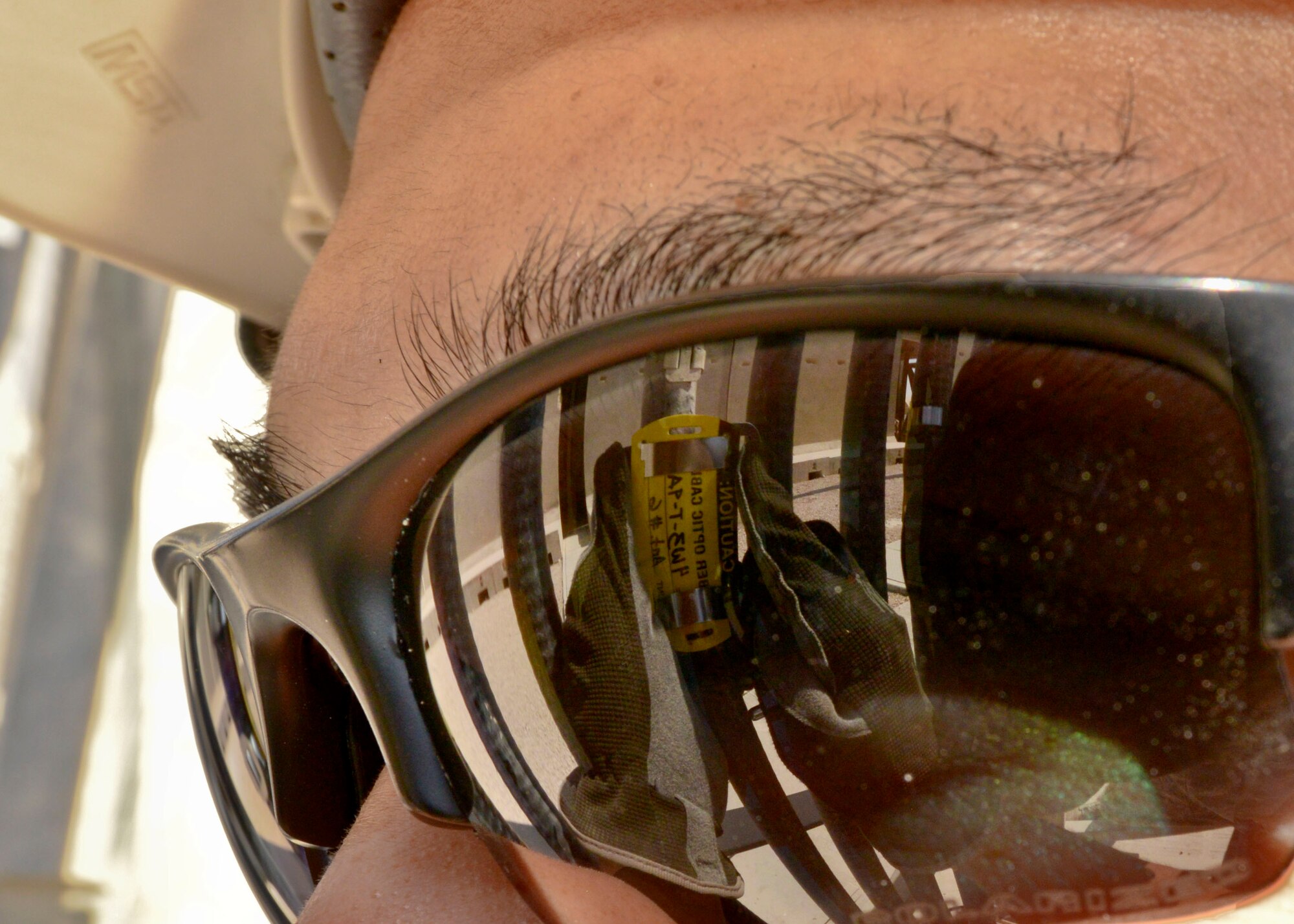 Senior Airman Wong Ly labels an antenna cable at the 379th Air Expeditionary Wing in Southwest Asia, Oct. 30, 2013. Cables are labeled to track communication wire routes from the antenna tower to a radio control switch. Ly is a 379th Expeditionary Communications Squadron cable and antenna maintainer deployed from Kadena Air Base Japan and a native of Hilo, Hawaii. (U.S. Air Force photo/Tech. Sgt. Joselito Aribuabo)