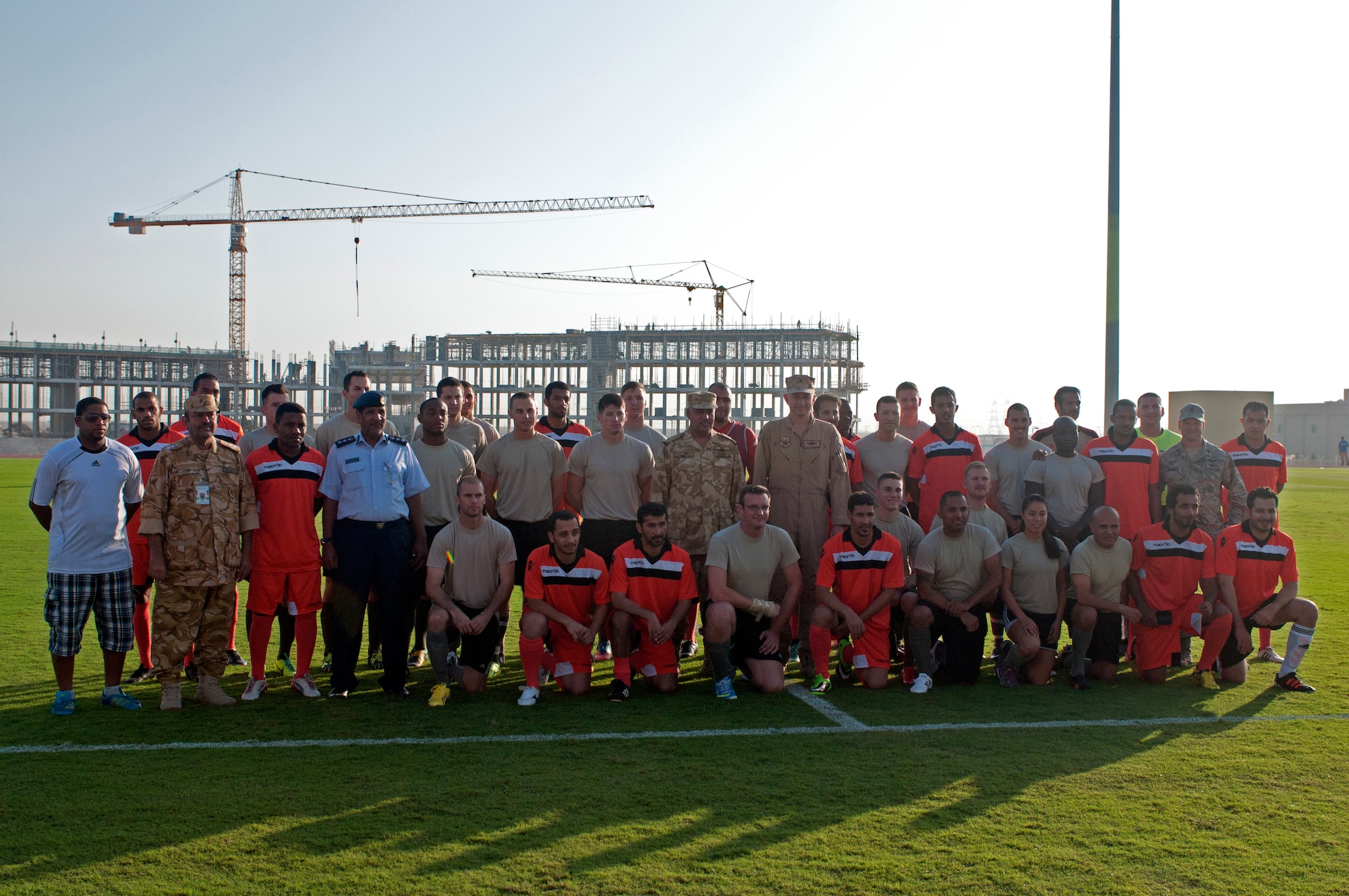 Team members from the U.S. Air Force and host nation pose with base leadership for a group shot just before a Friendship Games tournament soccer match at the 379th Air Expeditionary Wing in Southwest Asia Oct. 27, 2013. The tournament was a friendly illustration of the partnership between the United States, the United Kingdom, and the local military counterparts and was held at the host nation’s soccer compound on base. (U.S. Air Force photo/1st Lt. Susan Harrington)