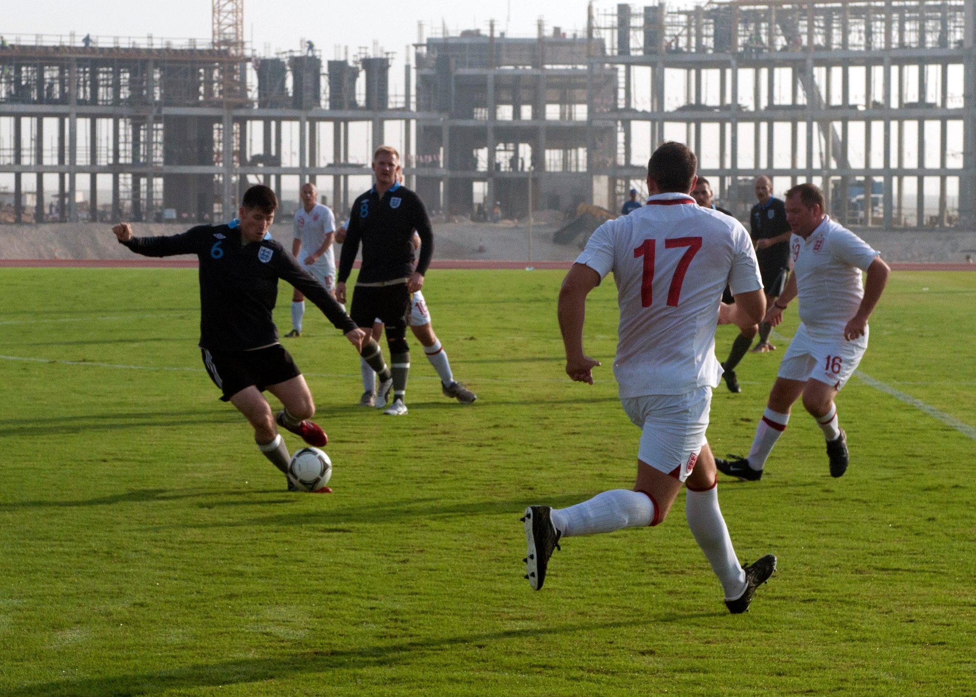 U.S. Air Force and Royal Air Force service members faceoff during a Friendship Games tournament soccer match at the 379th Air Expeditionary Wing in Southwest Asia Oct. 27, 2013. The tournament was a friendly illustration of the partnership between the United States, the United Kingdom, and the local military counterparts and was held at the host nation’s soccer compound on base. (U.S. Air Force photo/1st Lt. Susan Harrington)