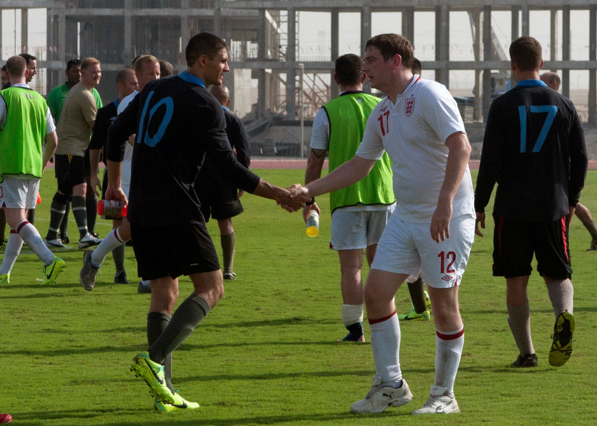 Royal Air Force and U.S. service members shake hands in good sport after playing a friendly soccer match at the 379th Air Expeditionary Wing in Southwest Asia Oct. 29, 2013. U.S., Royal Air Force and host nation service members from across the base participated in a Friendship Games tournament illustrating the partnership between the United States, the United Kingdom, and the local host nation. (U.S. Air Force photo/1st Lt. Susan Harrington)