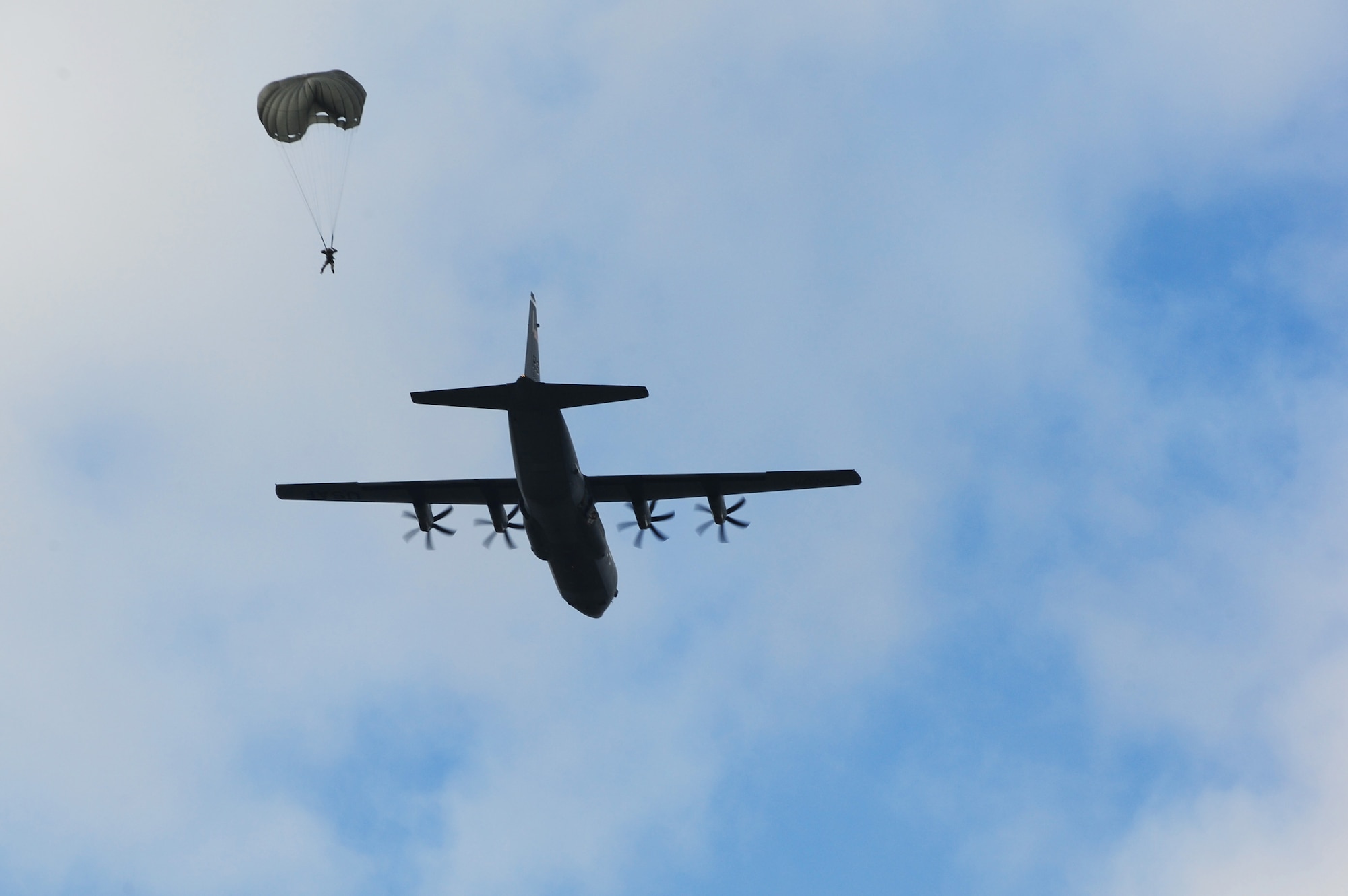 An Airman from the 435th Contingency Response Group jumps out of a C-130J Super Hercules during a theater security cooperation event, Oct. 24, 2013, Powidz Air Transport Base, Poland. Generally, jumpers are used to secure and protect a new landing zone prior to aircraft landing. 
 (U.S. Air Force photo/Senior Airman Hailey Haux)

