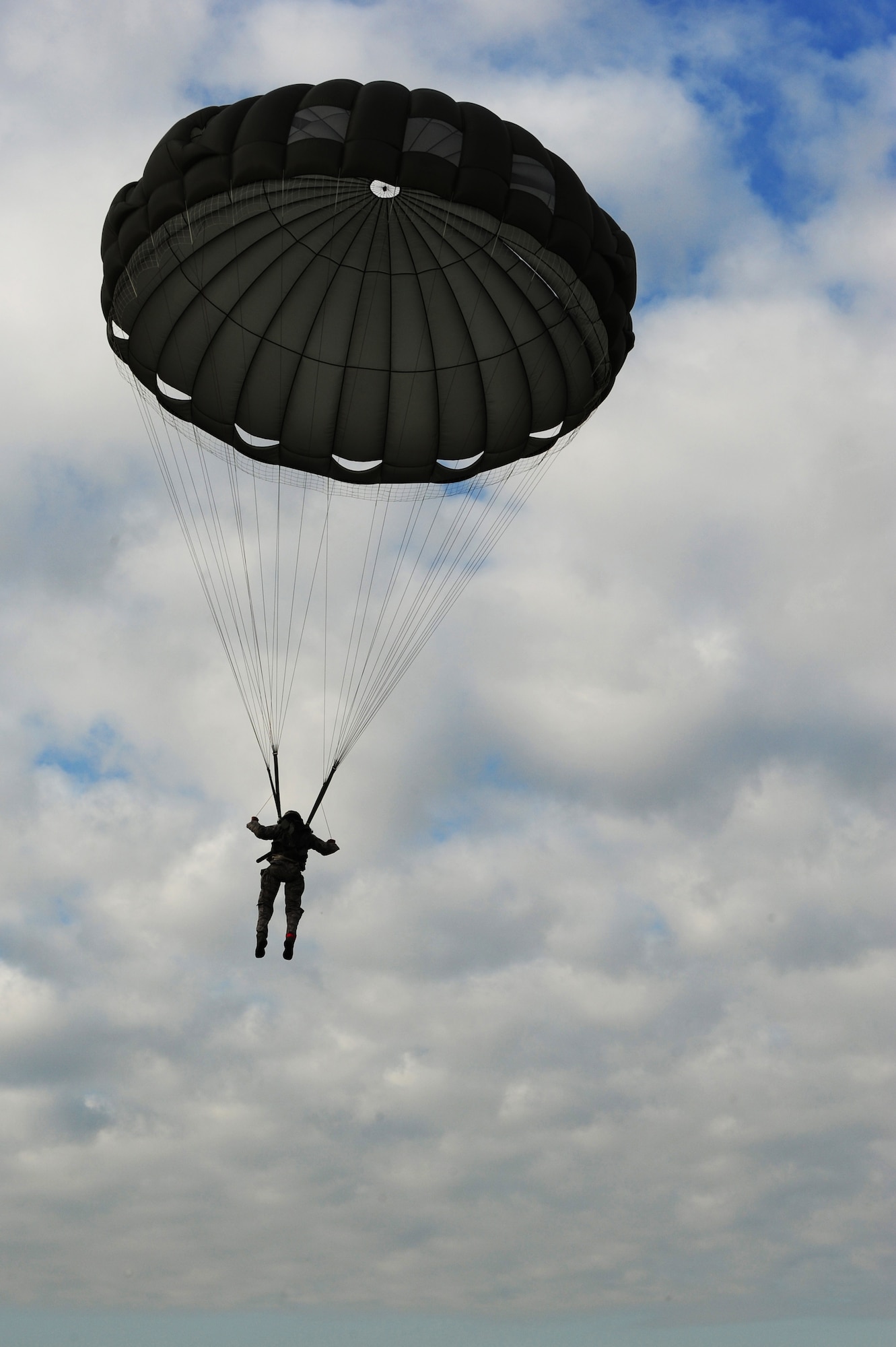 An Airman from the 435th Contingency Response Group jumps out of a C-130J Super Hercules during a theater security cooperation event, Oct. 24, 2013, Powidz Air Transport Base, Poland. Generally, jumpers are used to secure and protect a new landing zone prior to aircraft landing. 
 (U.S. Air Force photo/Senior Airman Hailey Haux)
