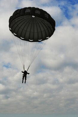 An Airman from the 435th Contingency Response Group jumps out of a C-130J Super Hercules during a theater security cooperation event, Oct. 24, 2013, Powidz Air Transport Base, Poland. Generally, jumpers are used to secure and protect a new landing zone prior to aircraft landing. 
 (U.S. Air Force photo/Senior Airman Hailey Haux)
