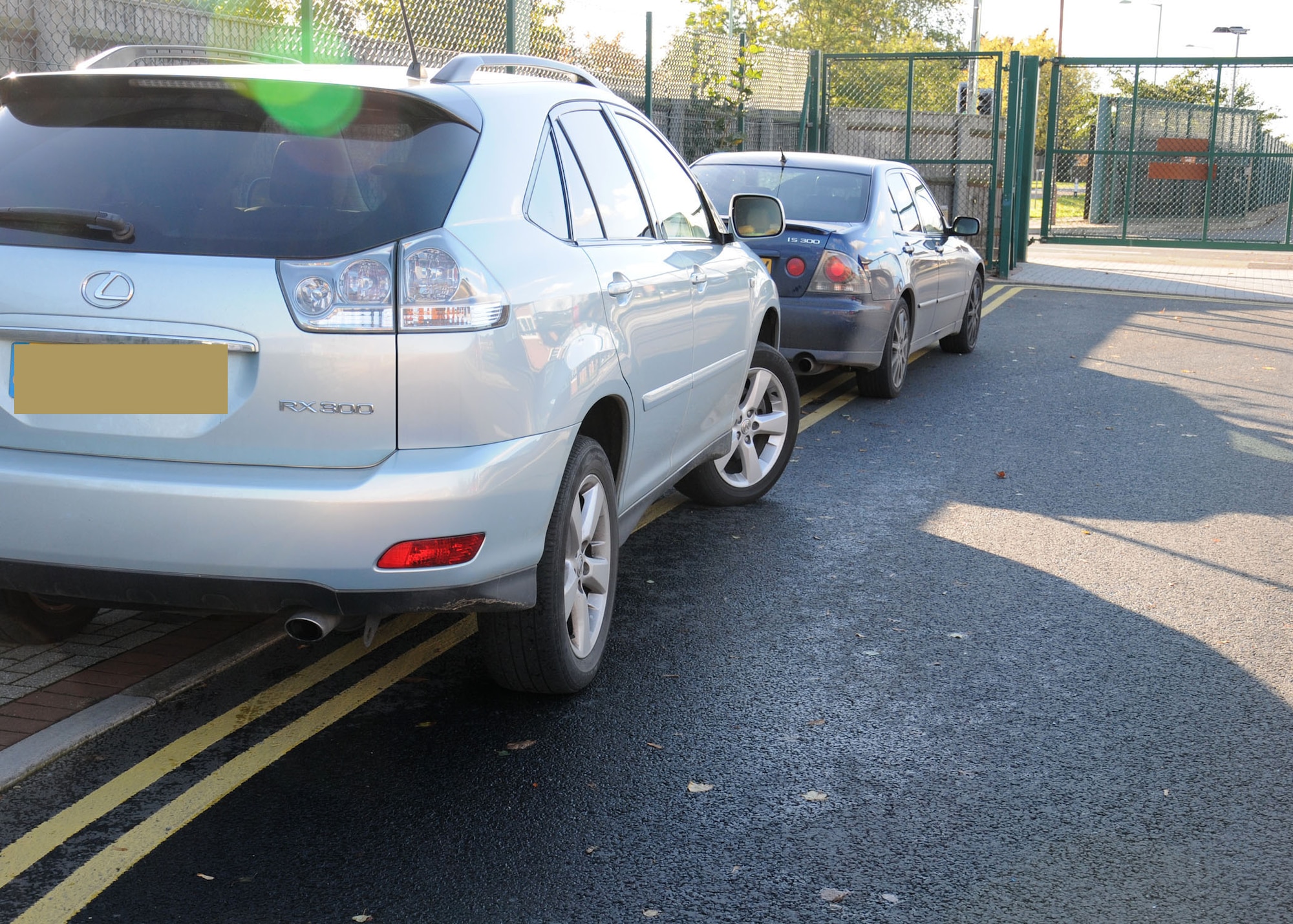 Parents leave their cars illegally parked on double yellow lines while they collect their children Oct. 23, 2013, from the Youth Center on RAF Mildenhall, England. At times the staff has noticed people dropping their cars off and leaving them for the day; now they put a notice on the customer’s car asking them to refrain from doing this in the future. Editor’s note: this photo was edited for privacy purposes. (U.S. Air Force photo by Gina Randall/Released) 