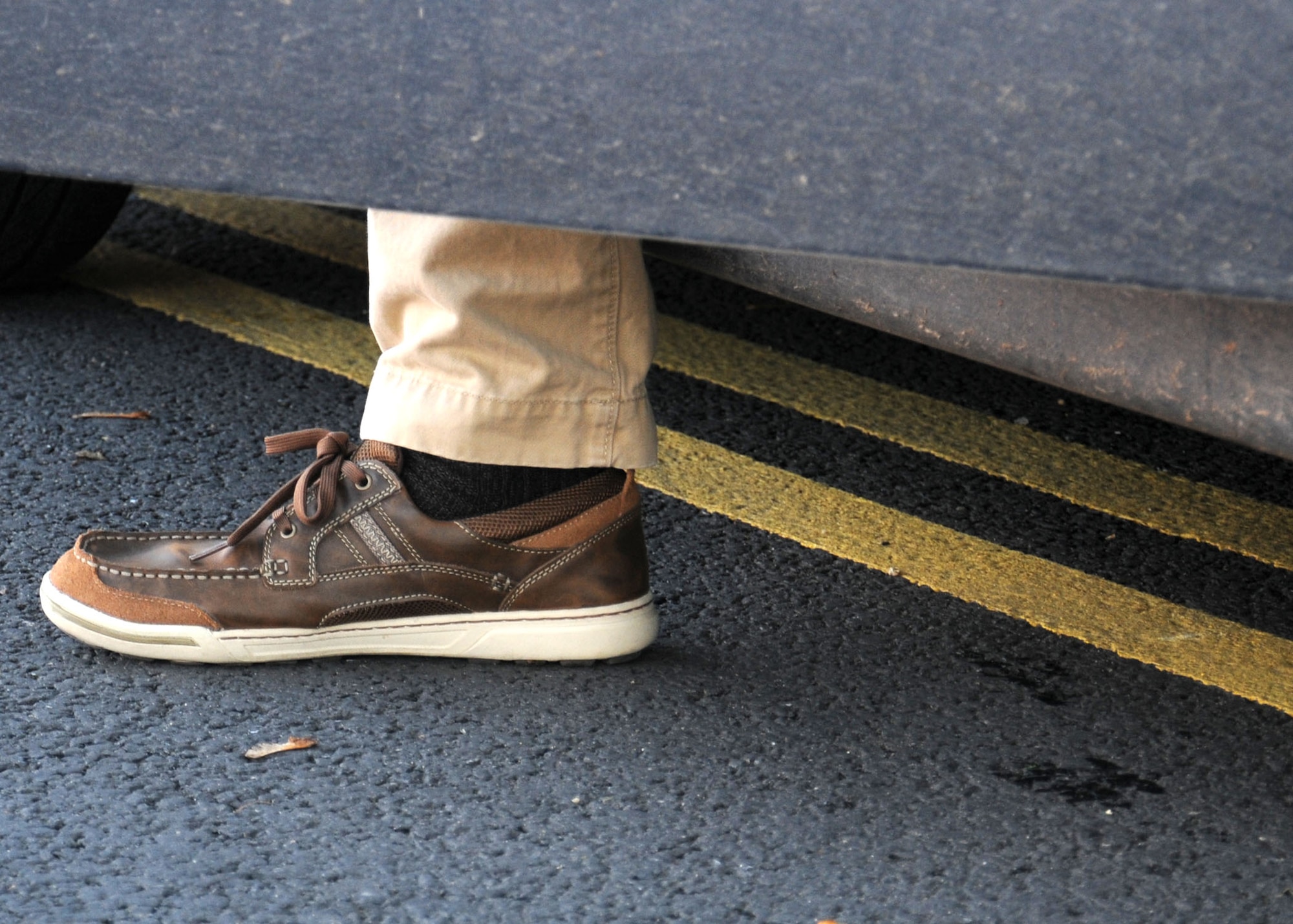 A parent of a child attending the RAF Mildenhall Youth Center leaves his car illegally parked on double yellow lines while he collects his child Oct. 23, 2013, from the YC on RAF Mildenhall, England. Parking and waiting is only authorized in designated or marked parking spaces. Failure to park a vehicle safely creates a major safety concern for Team Mildenhall children. (U.S. Air Force photo by Gina Randall/Released) 