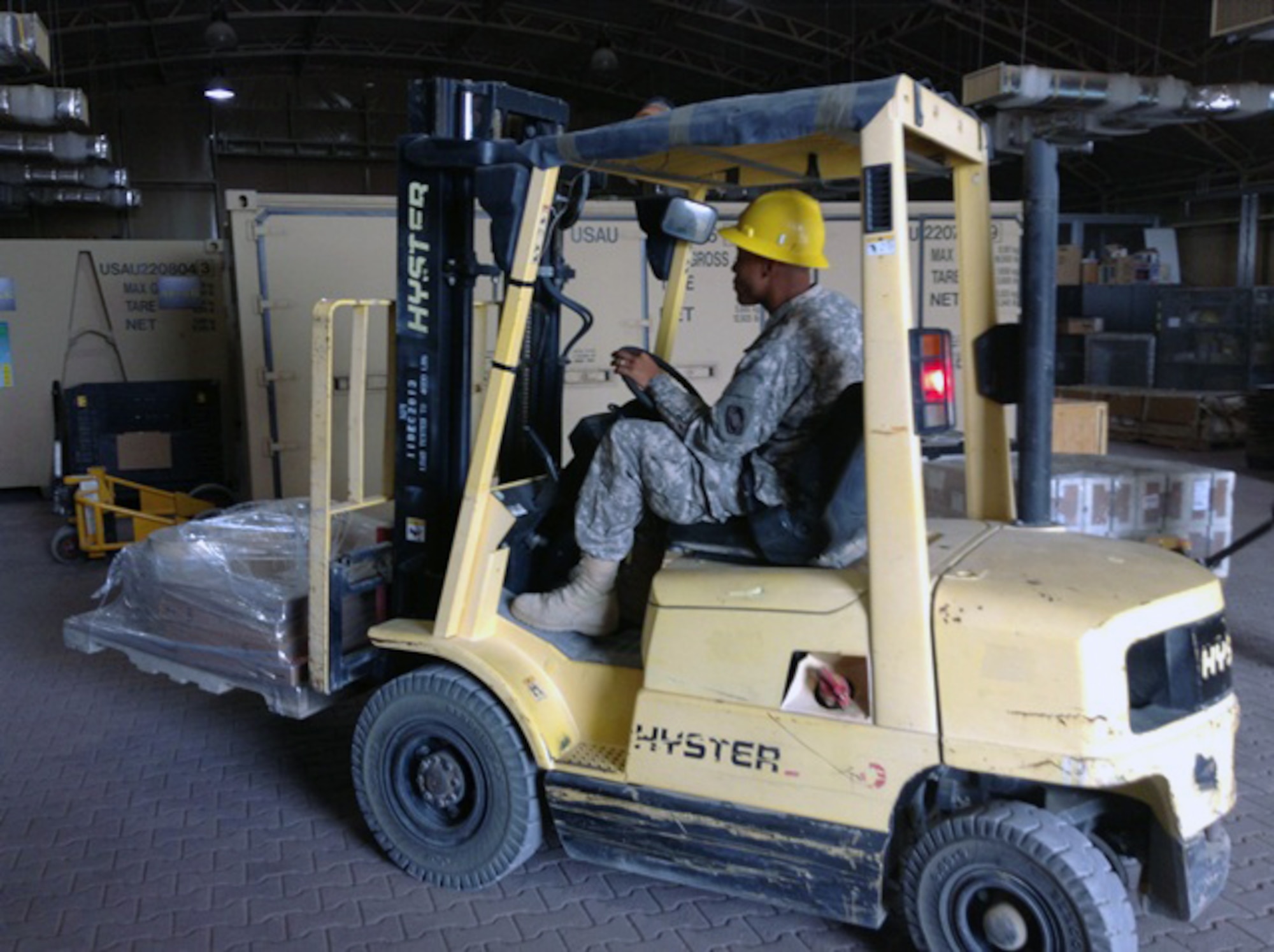 Pfc. Joseph Jones, Foxtrot Company, 1st Battalion 44th Air Defense Artillery Regiment, operates a forklift to transport parts from a flatbed trailer to a resting site inside the Supply Support Activities warehouse at an undisclosed location in Southwest Asia, Sept. 21, 2013. The parts will remain in storage at the warehouse until picked up by the personnel who ordered the supplies. Foxtrot Co.’s SSA recently received the Department of the Army Supply Excellence Award. (U.S. Army photo/2nd Lt. Spencer Ferrebee)