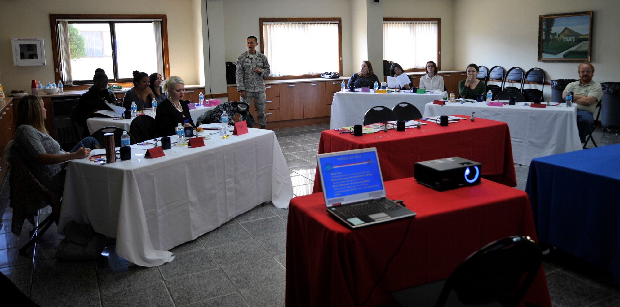 Staff Sgt. Ymir Eboras, 51st Comptroller Squadron quality examination technician, briefs spouses about leave and earning statements during a Heart Link orientation at the chapel annex at Osan Air Base, Republic of Korea, Nov. 7, 2013. Organizations from the base and local community attend the program to meet with spouses and give them information about the base and what it has to offer. (U.S. Air Force photo/Staff Sgt. Emerson Nuñez)