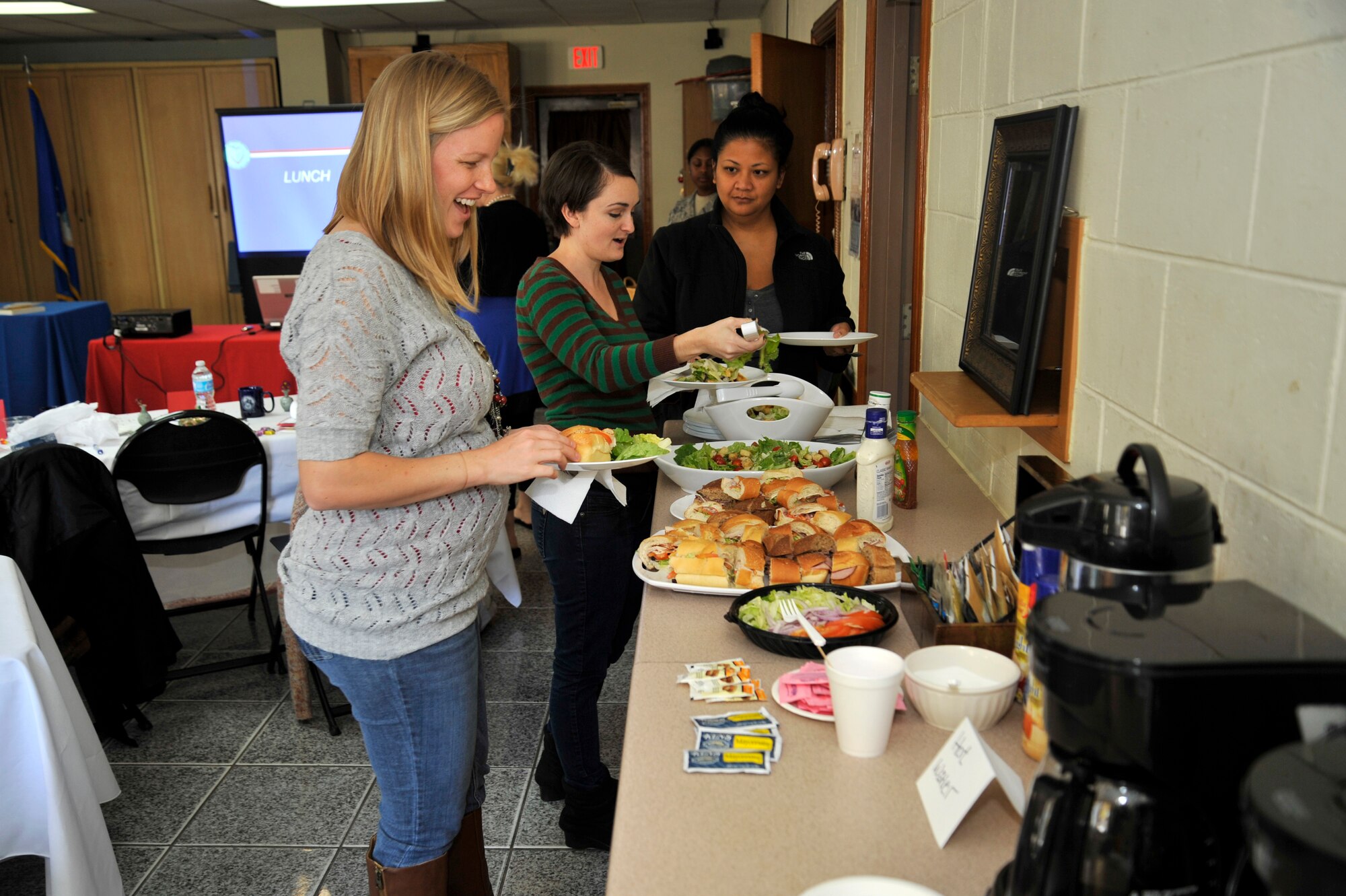 Arielle Huggins, left, Courtney White and Mary Roberts, Osan spouses, enjoy the free lunch offered during a Heart Link orientation at the chapel annex at Osan Air Base, Republic of Korea, Nov. 7, 2013. Different organizations from the base and local community attend the program to meet with other spouses and inform them about the base and what it has to offer. (U.S. Air Force photo/Staff Sgt. Emerson Nuñez)