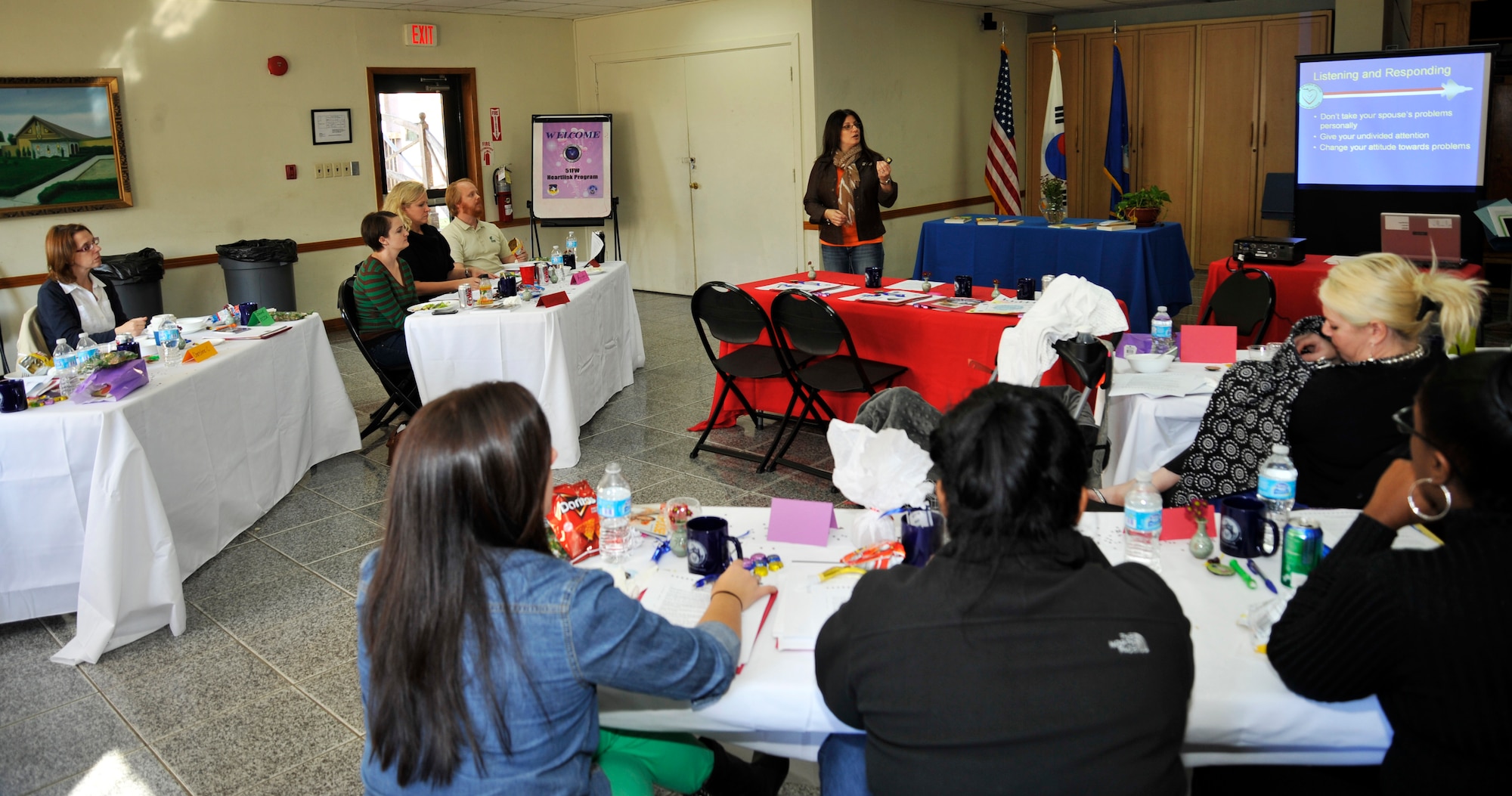 Christine Criswell, wife of Chief Master Sgt. Brendan Criswell, 51st FW command chief, briefs spouses on communication during a Heart link orientation at the chapel annex at Osan Air Base, Republic of Korea, Nov. 7, 2013. Osan's Heart Link program is open to all spouses of military members stationed here and is held every quarter. (U.S. Air Force photo/Staff Sgt. Emerson Nuñez)