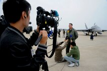 Media gathers to interview Lt. Col. Patrick Houlahan, VMFA-112 pilot, during the Max Thunder exercise at Kunsan Air Base, Republic of Korea, Nov. 6, 2013. Hosting members of the international media community enhances a global understanding and awareness of exercises like Max Thunder that demonstrate joint service capabilities. (U.S. Air Force photo by Staff Sgt. Jessica Haas/Released)