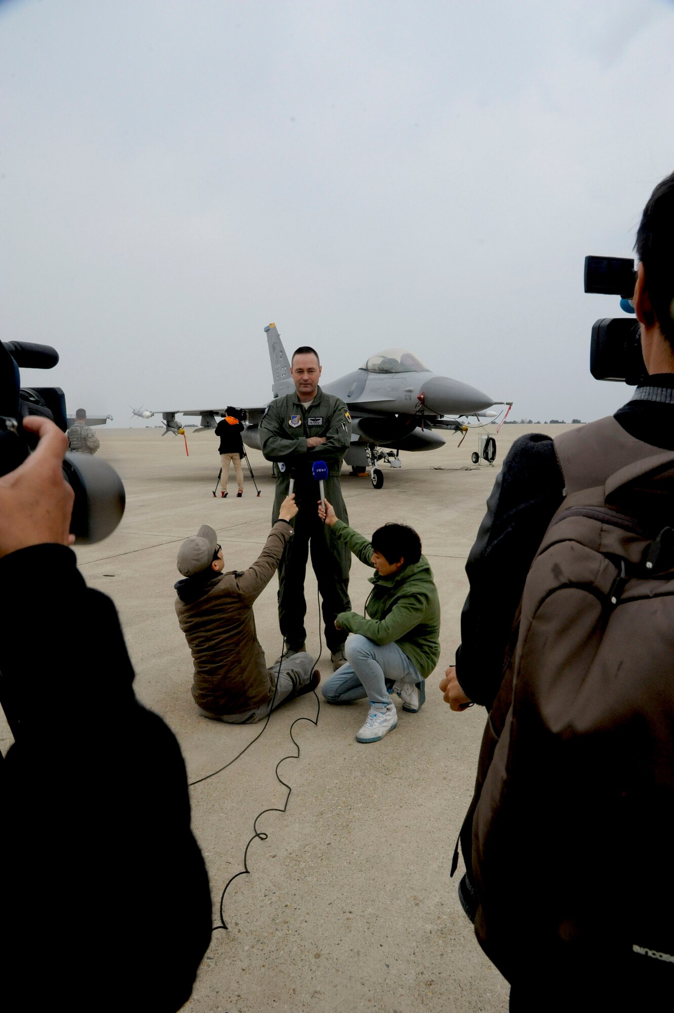 Media gathers to interview Col. Timothy Sundvall, 8th Fighter Wing vice commander, during the Max Thunder exercise at Kunsan Air Base, Republic of Korea, Nov. 6, 2013. Hosting members of the international media community enhances a global understanding and awareness of exercises like Max Thunder that demonstrate joint service capabilities. (U.S. Air Force photo by Staff Sgt. Jessica Haas/Released)