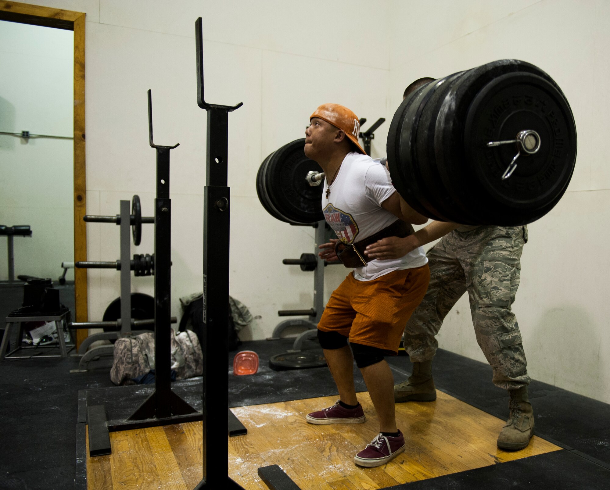 Airman 1st Class Benny Le, 8th Security Forces Squadron response force leader, performs a squat at Kunsan Air Base, Republic of Korea fitness center. Le is a member of the Air Force Powerlifting Team and is training for a competition in March. (U.S. Air Force photo by Senior Airman Clayton Lenhardt/Released)