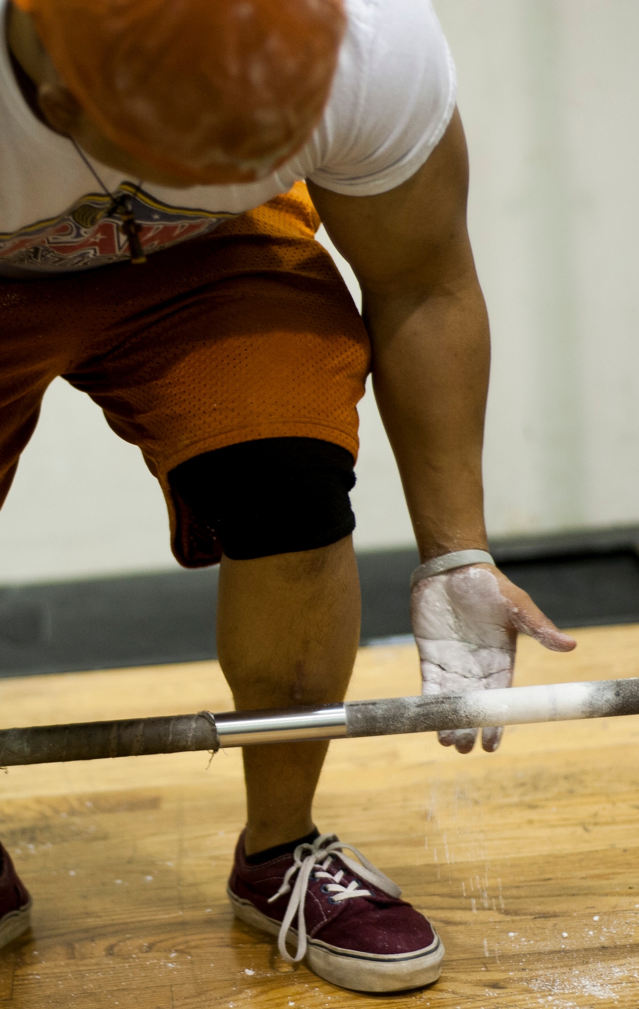 Airman 1st Class Benny Le, 8th Security Forces Squadron response force leader, chalks the bar before deadlifting at Kunsan Air Base, Republic of Korea fitness center. Le is a member of the Air Force Powerlifting Team and is training for a competition in March. (U.S. Air Force photo by Senior Airman Clayton Lenhardt/Released)