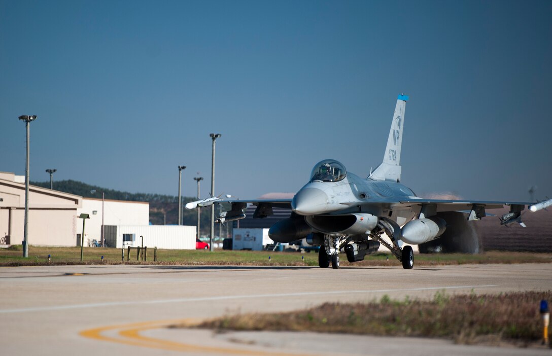 A 35th Fighter Squadron F-16 Fighting Falcon taxis towards the runway before taking off for the final sortie of Max Thunder at Kunsan Air Base, Republic of Korea, Nov. 7, 2013. Airmen from the U.S. Air Force, Marine Corps and the Republic of Korea air force continued their participation in scenarios and planning cycles in a robust exercise setting that simulated combined operations against a hostile force, Nov. 7, 2013. This combined large-force employment exercise includes 8th Fighter Wing F-16 Fighting Falcons, 51st Fighter Wing A-10 Thunderbolts II and F-16s, Marine Air Group 12 F-18 Hornets, AV-8B Harriers II, 35th Air Defense Artillery Brigade, 18th Wing E-3B Sentries, numerous ROKAF aircraft and accompanying support personnel during.  (U.S. Air Force photo by Senior Airman Armando A. Schwier-Morales/Released)
