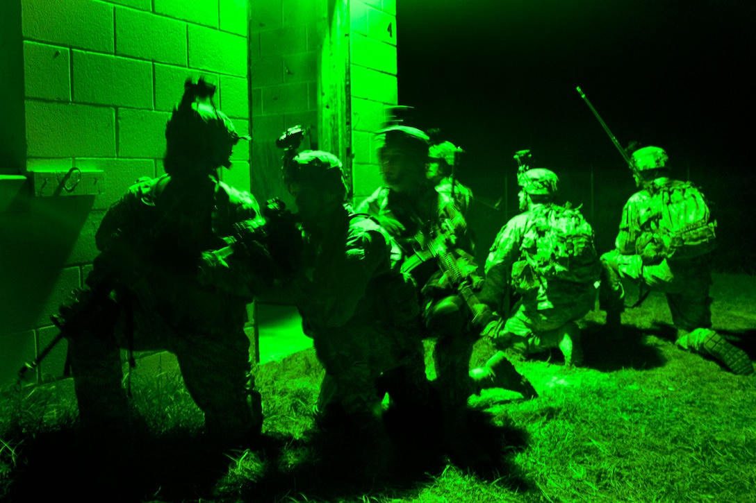 As seen through a night-vision device, paratroopers form a security formation and prepare to move to their next objective during a night operation mission on Fort Bragg, N.C., Oct. 31, 2013. 