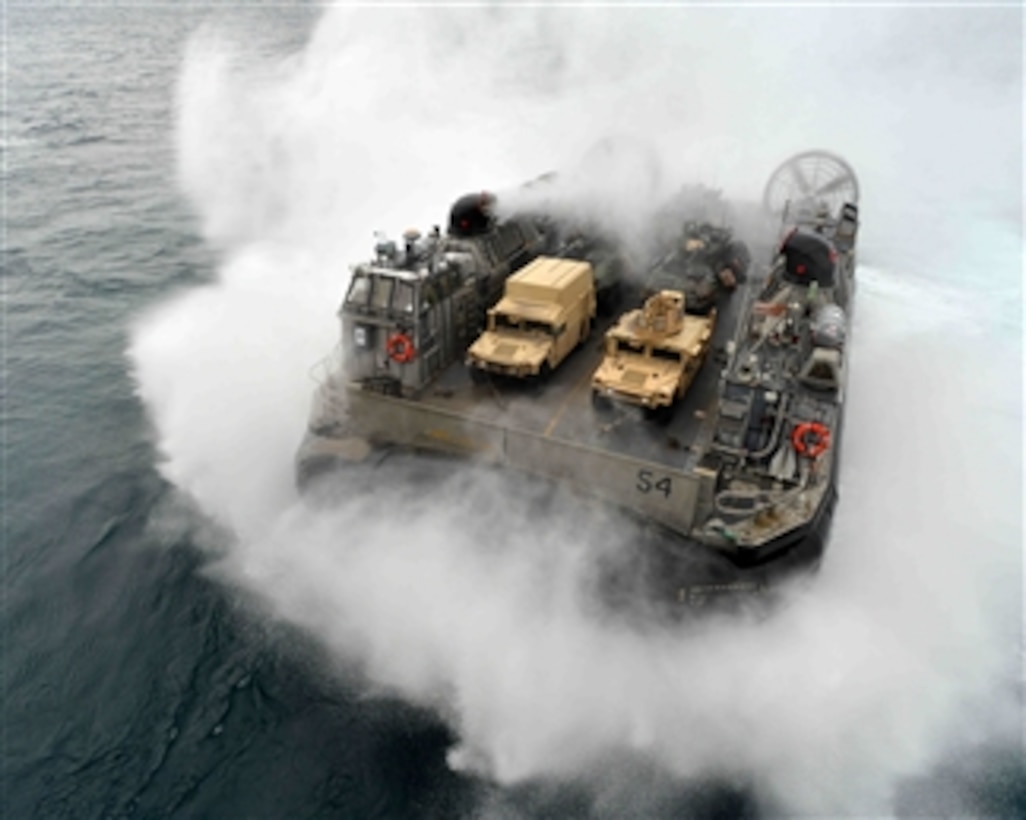 A U.S. Navy Landing Craft Air Cushion, more commonly known as an LCAC, approaches the well deck of the amphibious assault ship USS Bataan (LHD 5) in the Atlantic Ocean on Oct. 31, 2013.  The Bataan and the 22nd Marine Expeditionary Unit are underway conducting routine qualifications.  