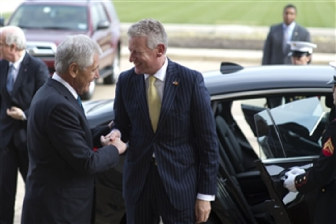 Secretary of Defense Chuck Hagel, left, greets Belgian Minister of Defense Pieter de Crem as he arrives at the Pentagon in Arlington, Va., on Nov. 5, 2013.  Hagel and de Crem will meet to discuss national and regional security items of interest to both nations.  