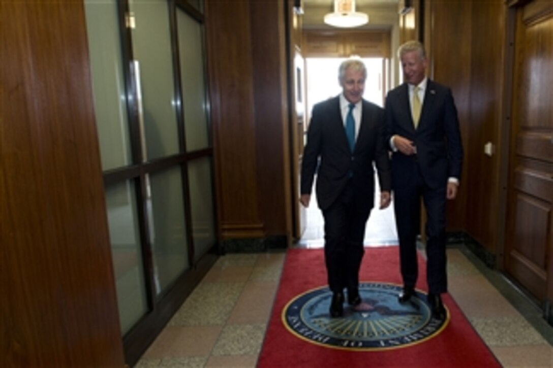 Secretary of Defense Chuck Hagel, left, escorts Belgian Minister of Defense Pieter de Crem to a meeting in the Pentagon in Arlington, Va., on Nov. 5, 2013.  Hagel and de Crem will meet to discuss national and regional security items of interest to both nations.  