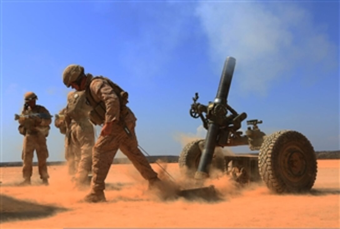 U.S. Marines with Alpha Battery, 1st Battalion, 4th Marine Regiment, 13th Marine Expeditionary Unit fire an M327 120mm towed mortar system during a sustainment training exercise in Djibouti on Oct. 30, 2013.  