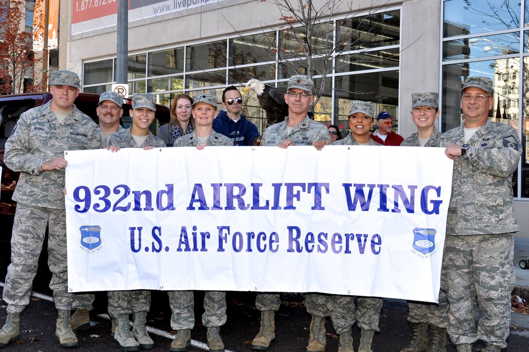 Members of the 932nd Airlift Wing pose with an American Bald Eagle, provided by the World Bird Sanctuary of Missouri, prior to marching in the annual Veteran's parade held November 9th, 2013 in St. Louis, Mo.  The 932nd Airlift Wing is known as the "Gateway" wing due to the close proximity across the Mississippi river in Illinois where the unit is located.  (U.S. Air Force Photo by Staff Sgt. Amber Hodges)