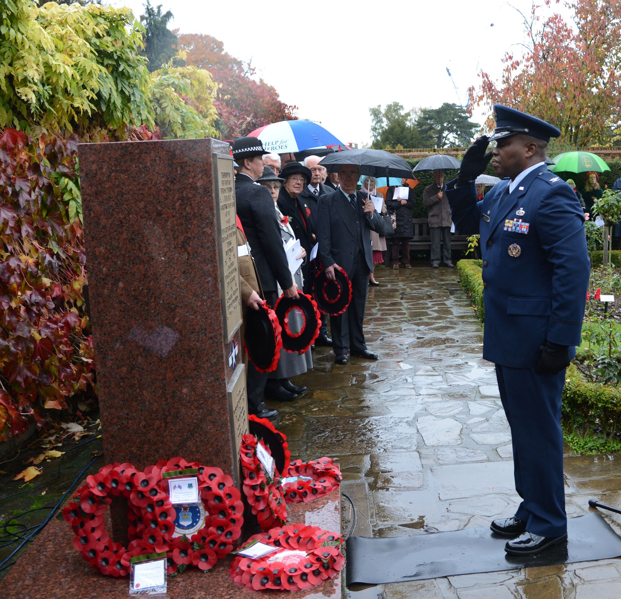 U.S. Air Force Col. Earl Scott, 100th Maintenance Group commander, salutes after laying a wreath during a Remembrance Day ceremony Nov. 9, 2013, in Bury St. Edmunds in Suffolk, England. The poppy was chosen as the symbol of remembrance because many British soldiers lost their lives in the poppy fields of Flanders, Belgium, during World War I. The day was originally named Armistice Day after World War I, which ended at the 11th hour on the 11th day of the 11th month in 1918. The day was changed to Remembrance Day after World War II to honor all of the men and women who serve. (U.S. Air Force photo by Airman 1st Class Kelsey Waters/Released)