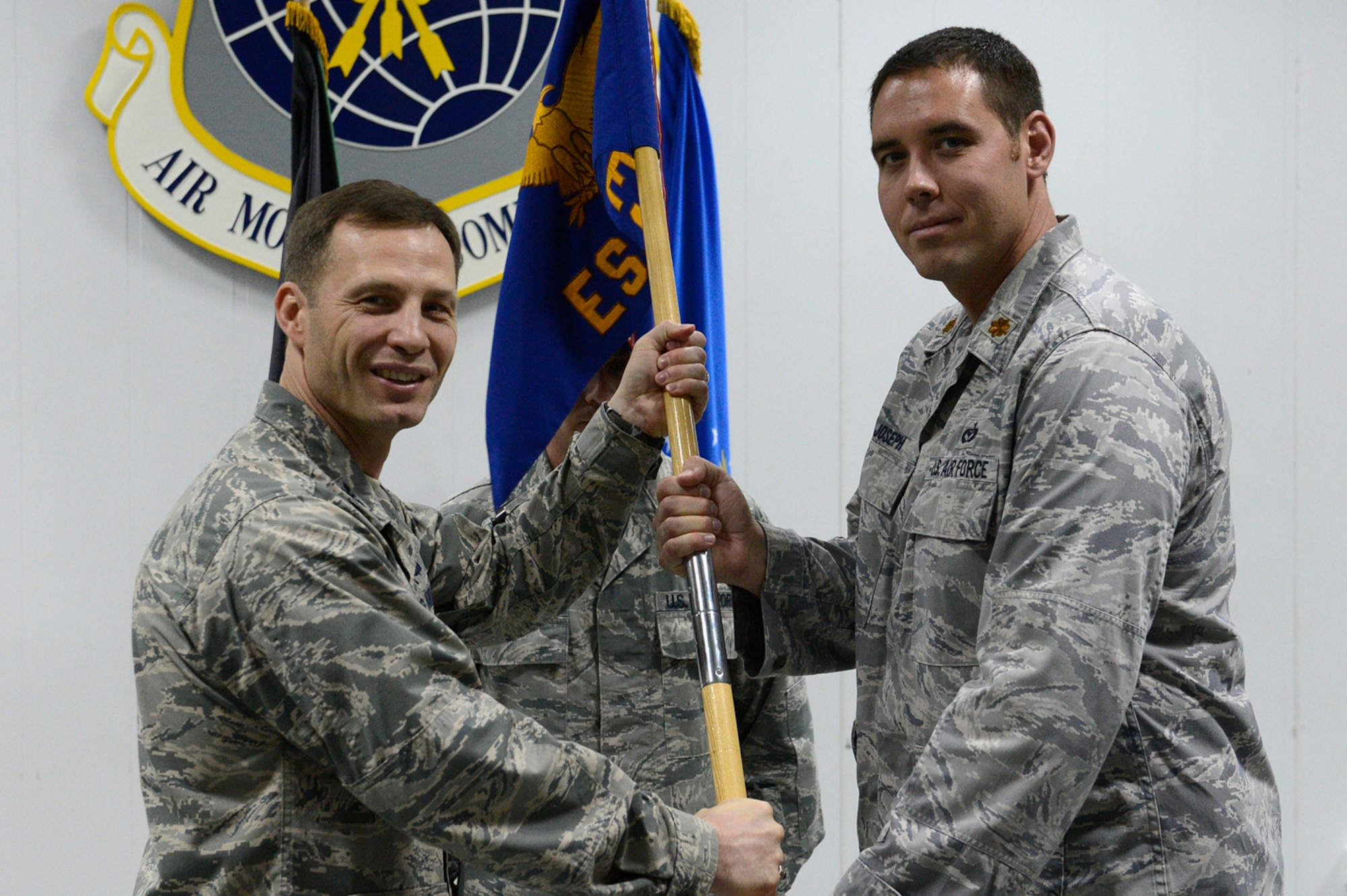 Colonel James D. Dryjanski, 387th Air Expeditionary Group commander, left, passes the 387th Expeditionary Support Squadron guidon to Maj. Matthew H. Joseph during an assumption of command ceremony at an undisclosed location in Southwest Asia November 8, 2013. (U.S. Air Force photo by Master Sgt. Christopher A. Campbell)