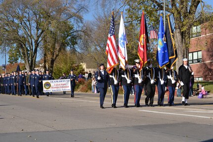 BELLEVUE, Neb. (Nov. 9, 2013) Service members assigned to U.S. Strategic Command (USSTRATCOM) march at the 14th annual Bellevue Veterans Day Parade. USSTRATCOM's marching group was comprised of more than 60 personnel representing the U.S. Army, Navy, Air Force, and Marine Corps. Along with USSTRATCOM, elements from the 55th Wing, Air Force Weather Agency, Bellevue schools, local businesses and special interest groups came together to thank veterans, past and present, for their service to our nation. (U.S. Navy photo by Mass Communication Specialist 1st Class Byron C. Linder/Released)