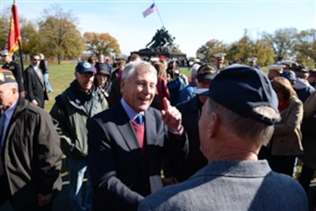 Defense Secretary Chuck Hagel speaks with veterans at the wreath-laying ceremony to honor the 238th-year legacy of the Marine Corps at the Iwo Jima War Memorial in Arlington, Va., Nov. 9, 2013.