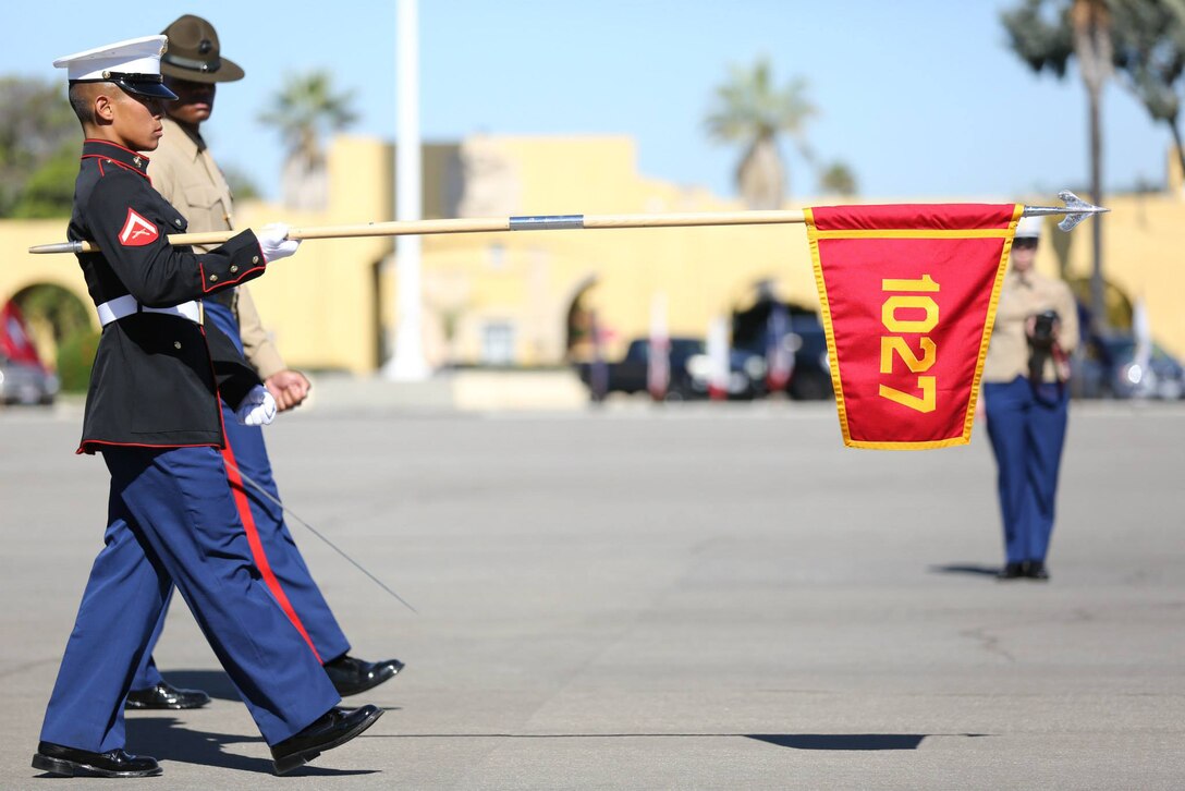 Lance Cpl. Jonathan N. Soeung, honor graduate for Bravo Company, and a Riverside, Calif., native stands with recruiter Staff Sgt. Christian Lopez (left) and senior drill instructor Staff Sgt. Joseph C. Hunt (right) after graduation at Marine Corps Recruit Depot San Diego, Nov. 8. Soeung was chosen as the company honor graduate because of his leadership skills, physical fitness and expert rifle score.