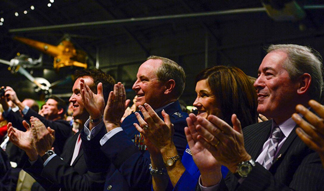 Acting Secretary of the Air Force Eric Fanning and Chief of Staff of the Air Force Gen. Mark A. Welsh III clap their hands after retired Lt. Col. Richard Cole opens the 1896 bottle of cognac during The Doolittle Raiders final toast at the National Museum of the U.S. Air Force Nov. 09, 2013 in Dayton, Ohio. Cole was the copilot of Aircraft No. 1.